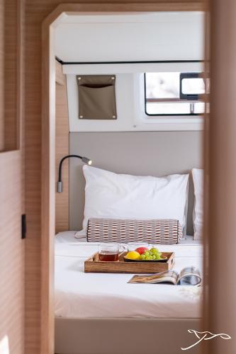 Luxurious cabin interior of 2025 Nautitech 44 Open with breakfast tray on bed.