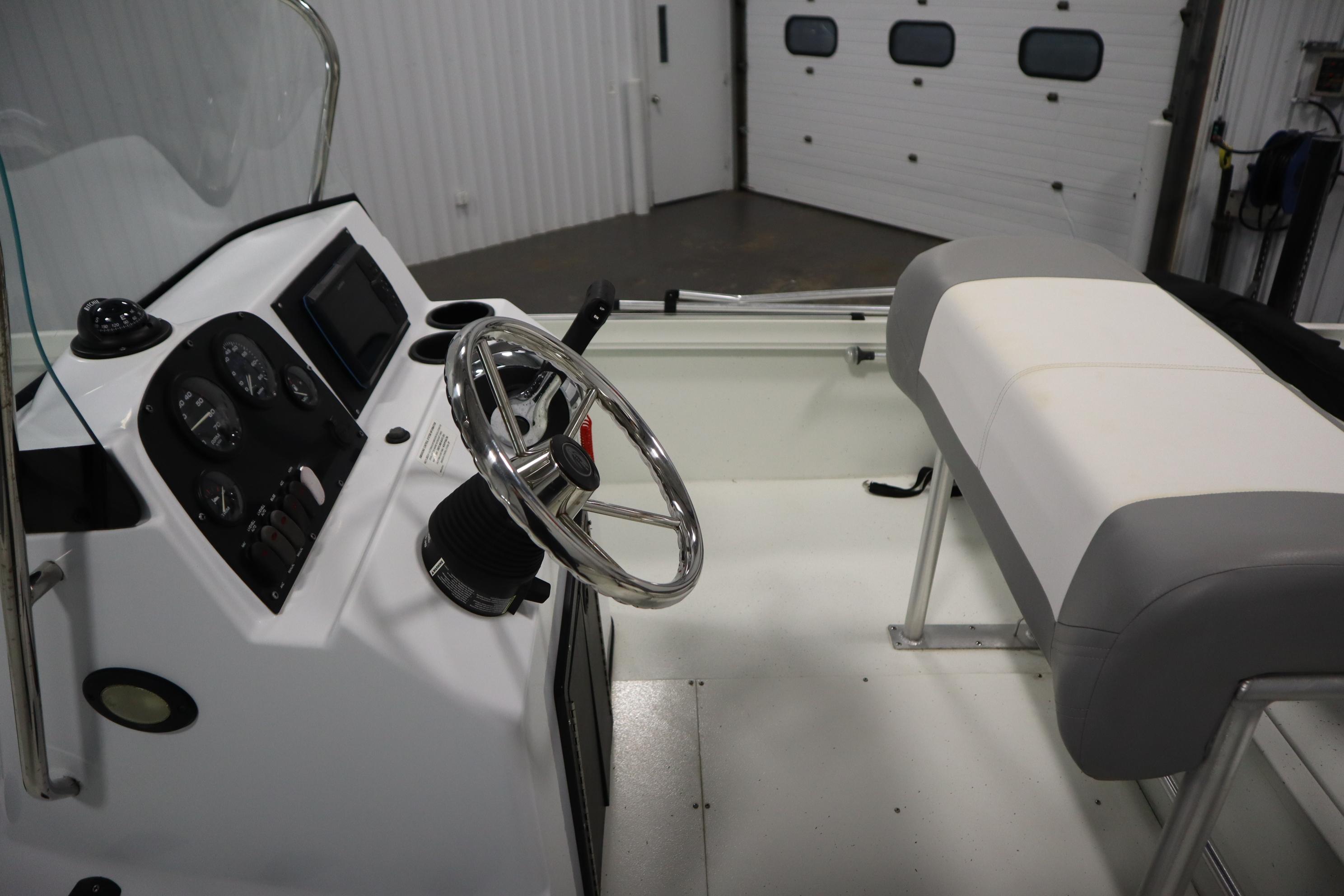 2022 Crestliner 2200 CC boat interior with steering wheel and dashboard controls.