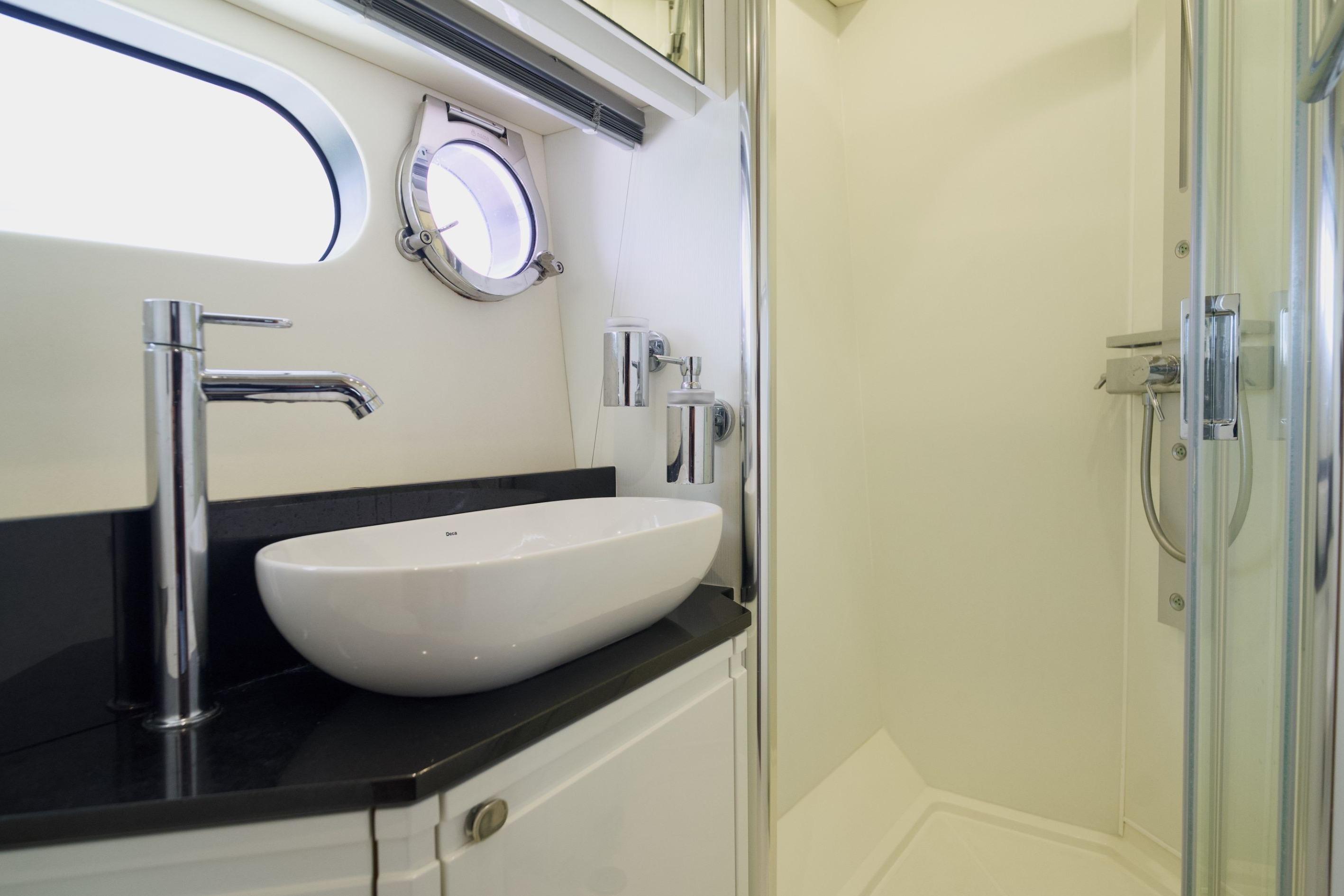 Luxurious bathroom in 2013 Sunseeker San Remo 485 yacht with modern sink and shower.