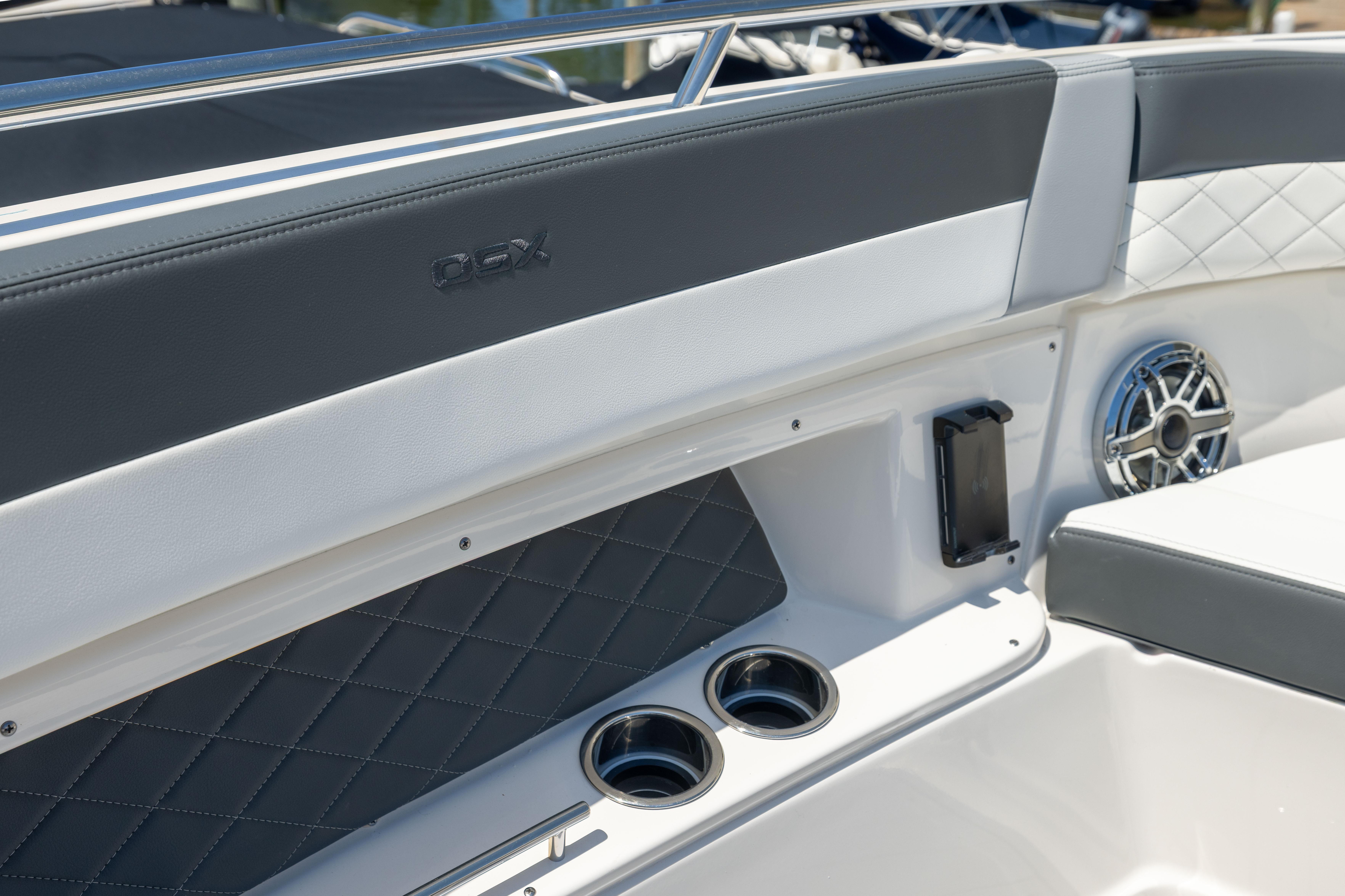 Interior of 2026 Chaparral 310 OSX boat with cup holders and speaker detail.