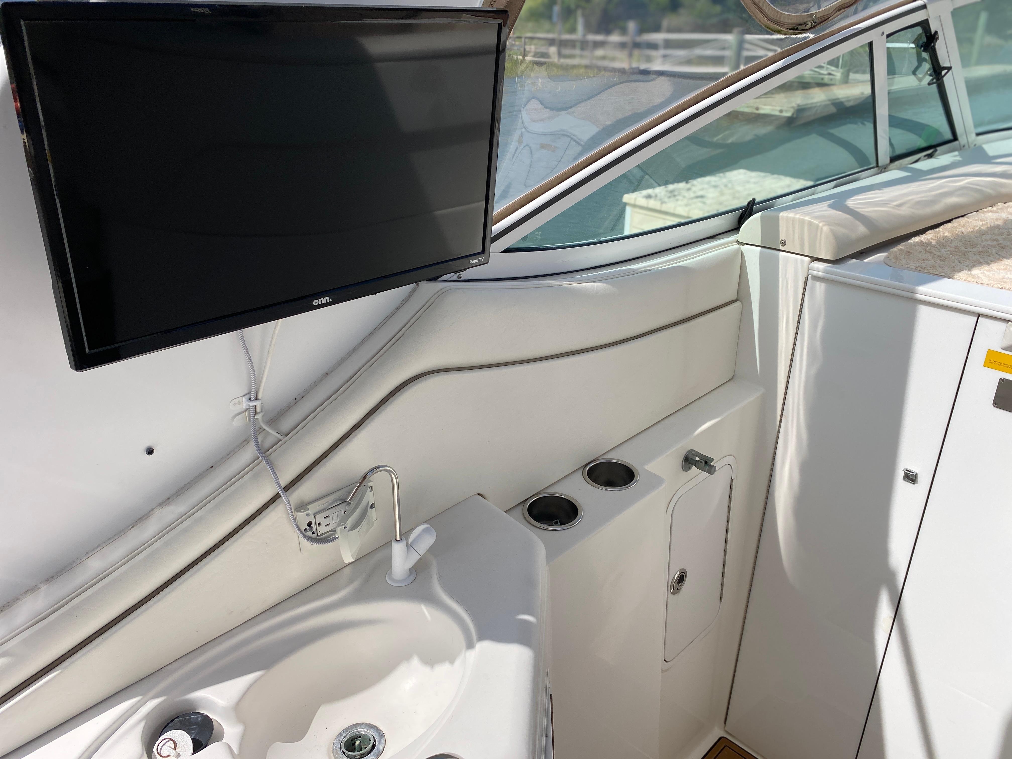 Interior of 2000 Cruisers 3672 yacht with sink, TV, and storage compartments.