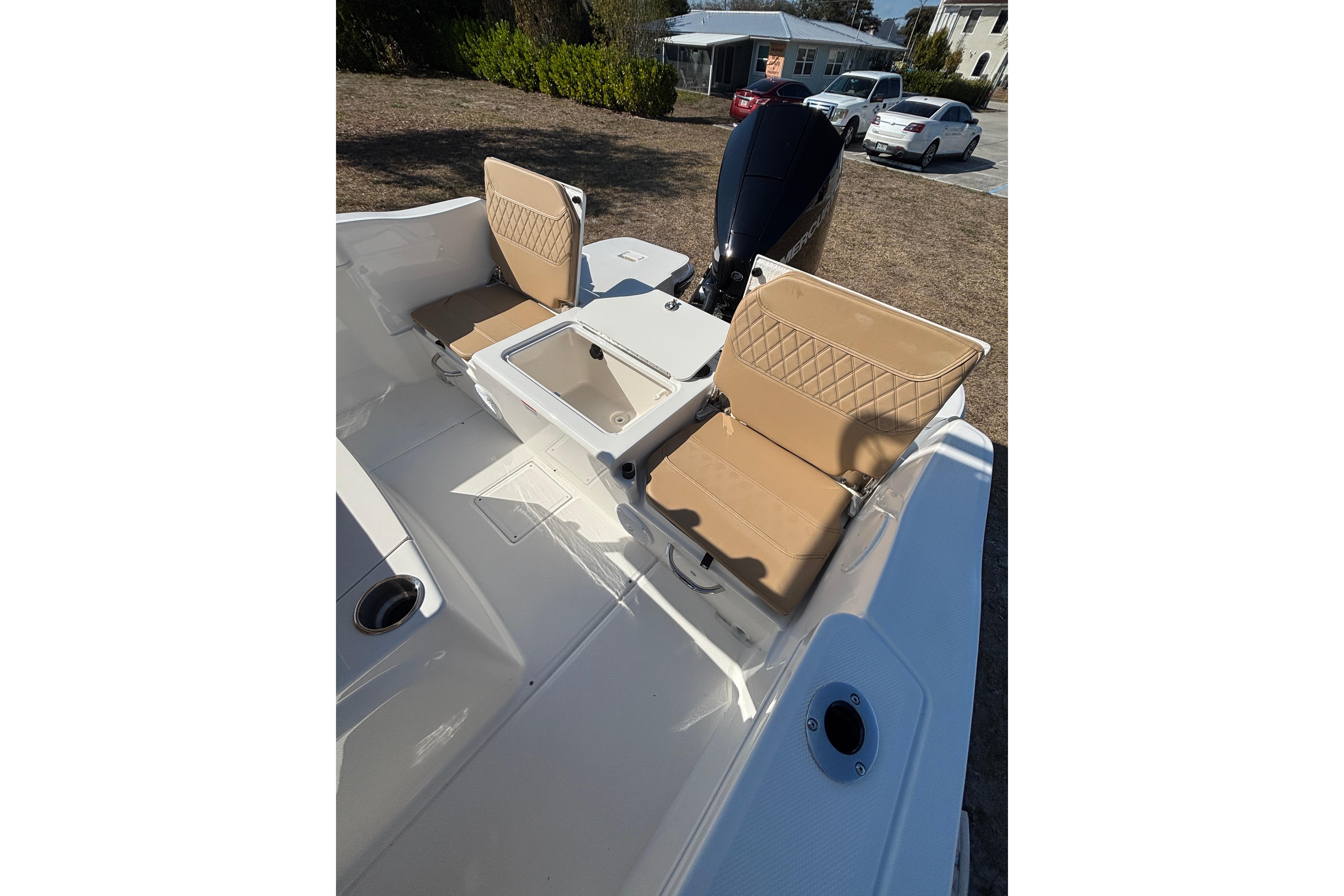 2026 Bayliner Trophy T22CC boat interior with tan seating and storage compartments.