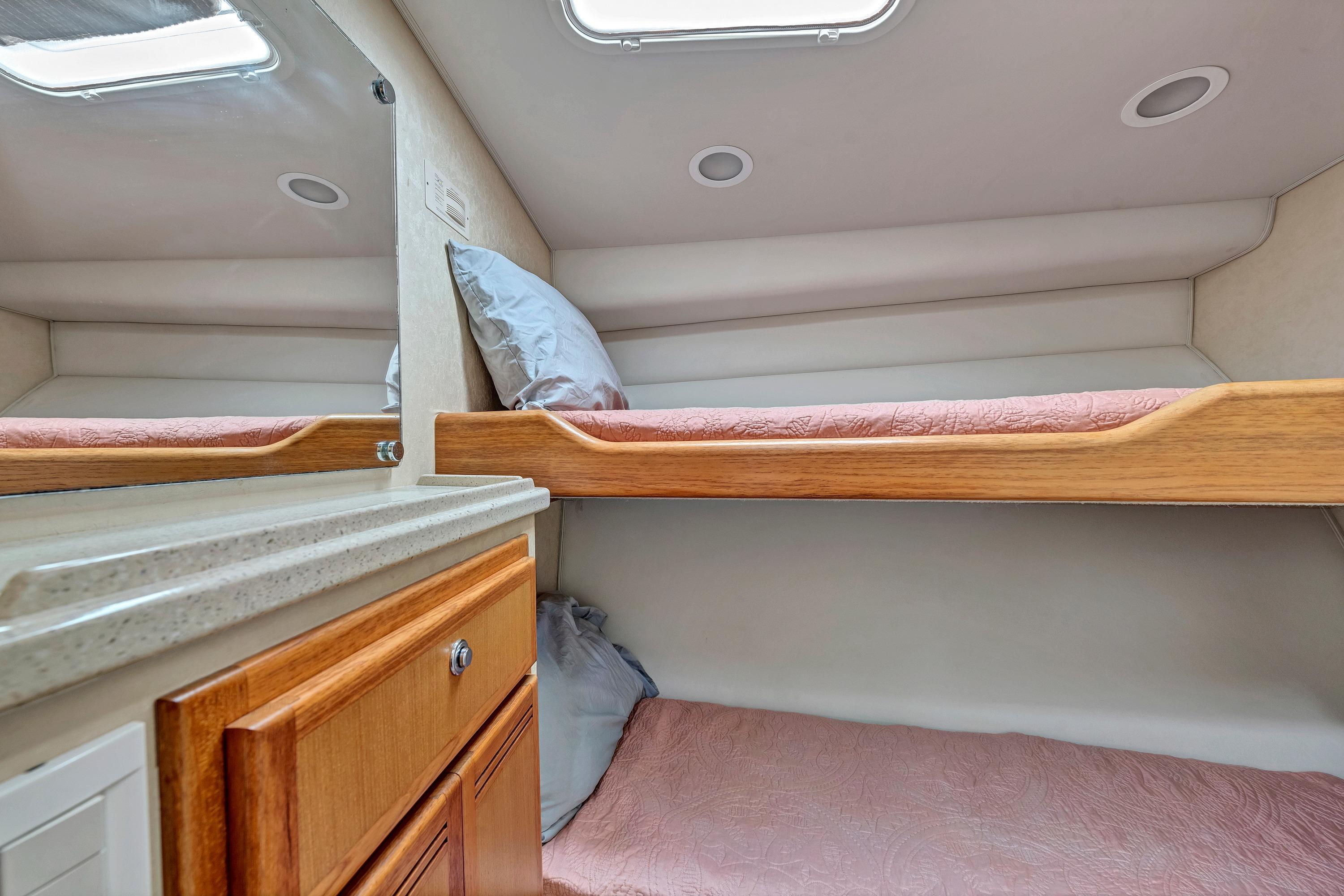 2010 Cabo 45 Express cabin interior with bunk beds and wooden cabinetry.