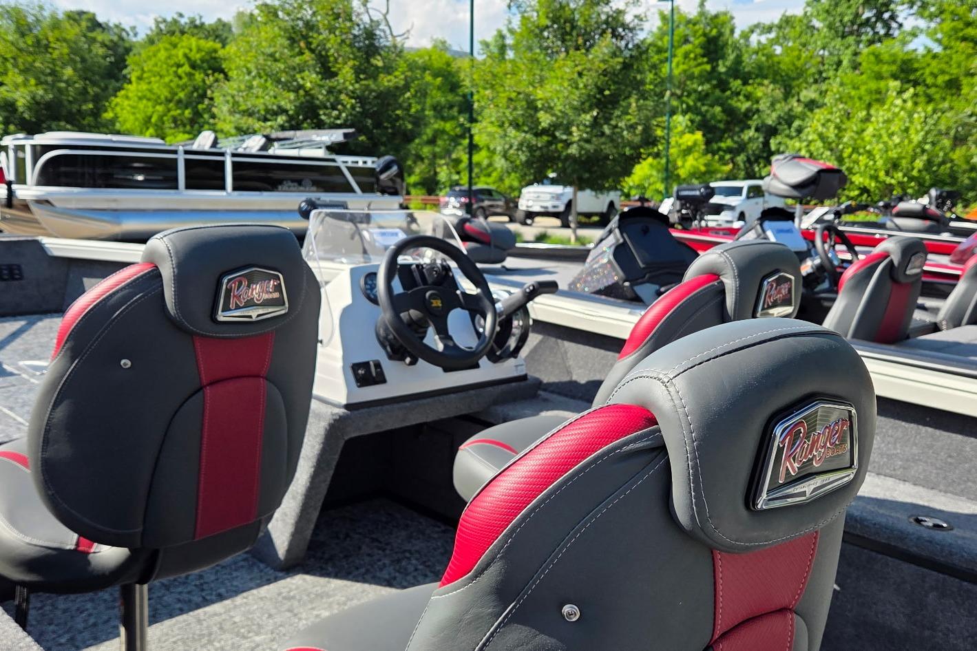 2026 Ranger VS1665SC boat interior with red and gray seats, steering wheel, and console.