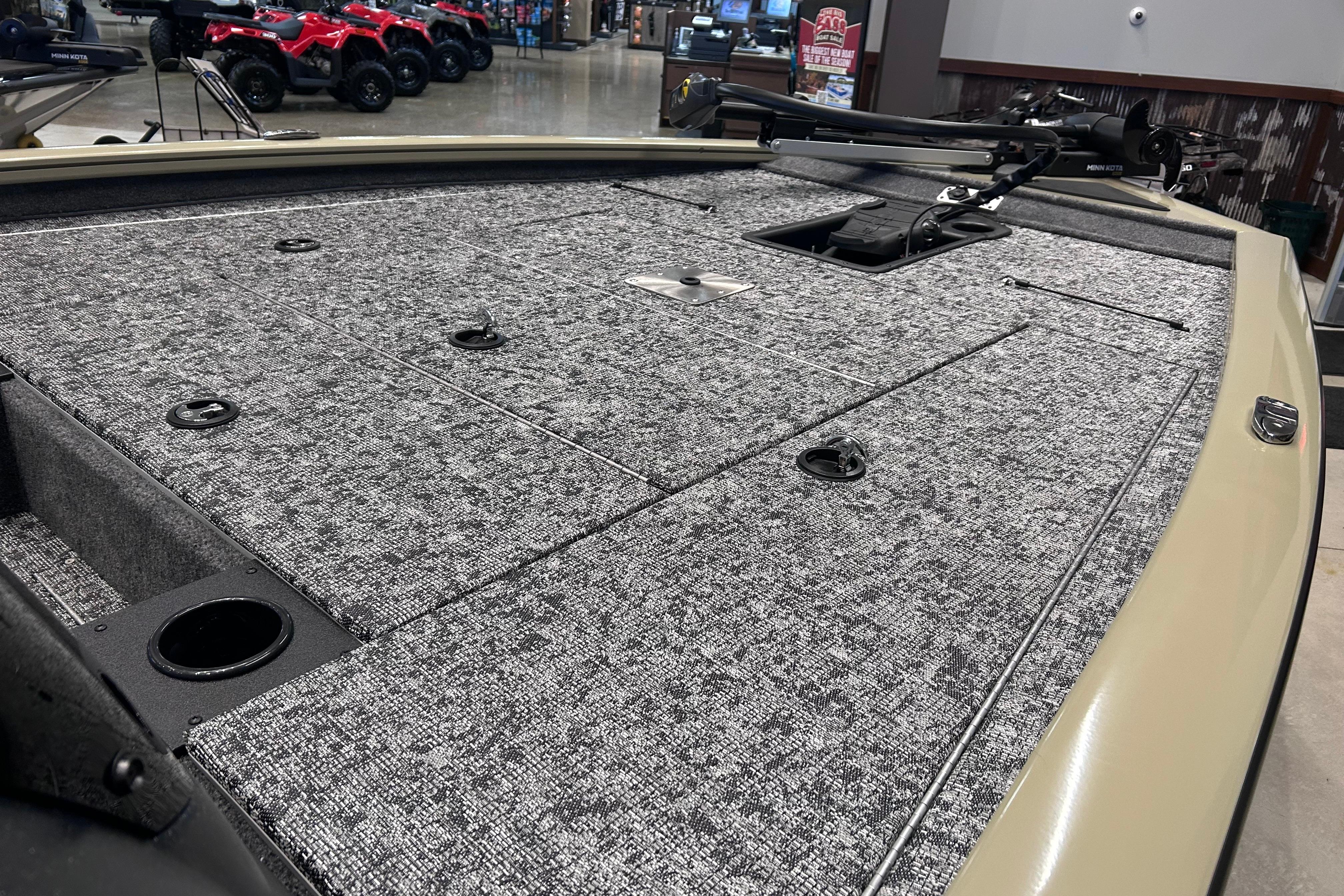2026 Tracker Pro Team 195 boat deck with carpeted surface and storage compartments.