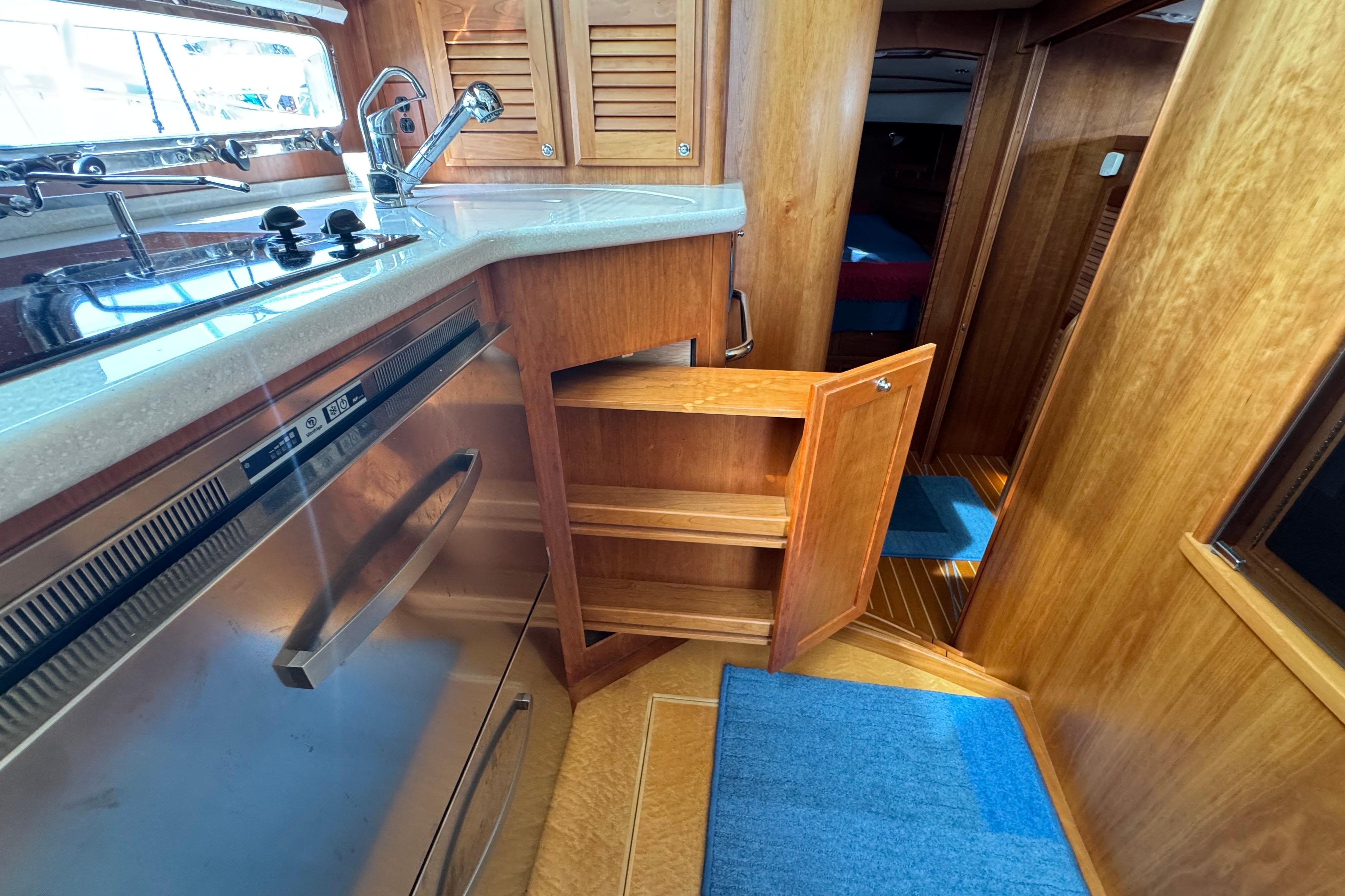 2016 Sabre Craft Salon Express interior with wooden cabinetry and modern kitchen amenities.