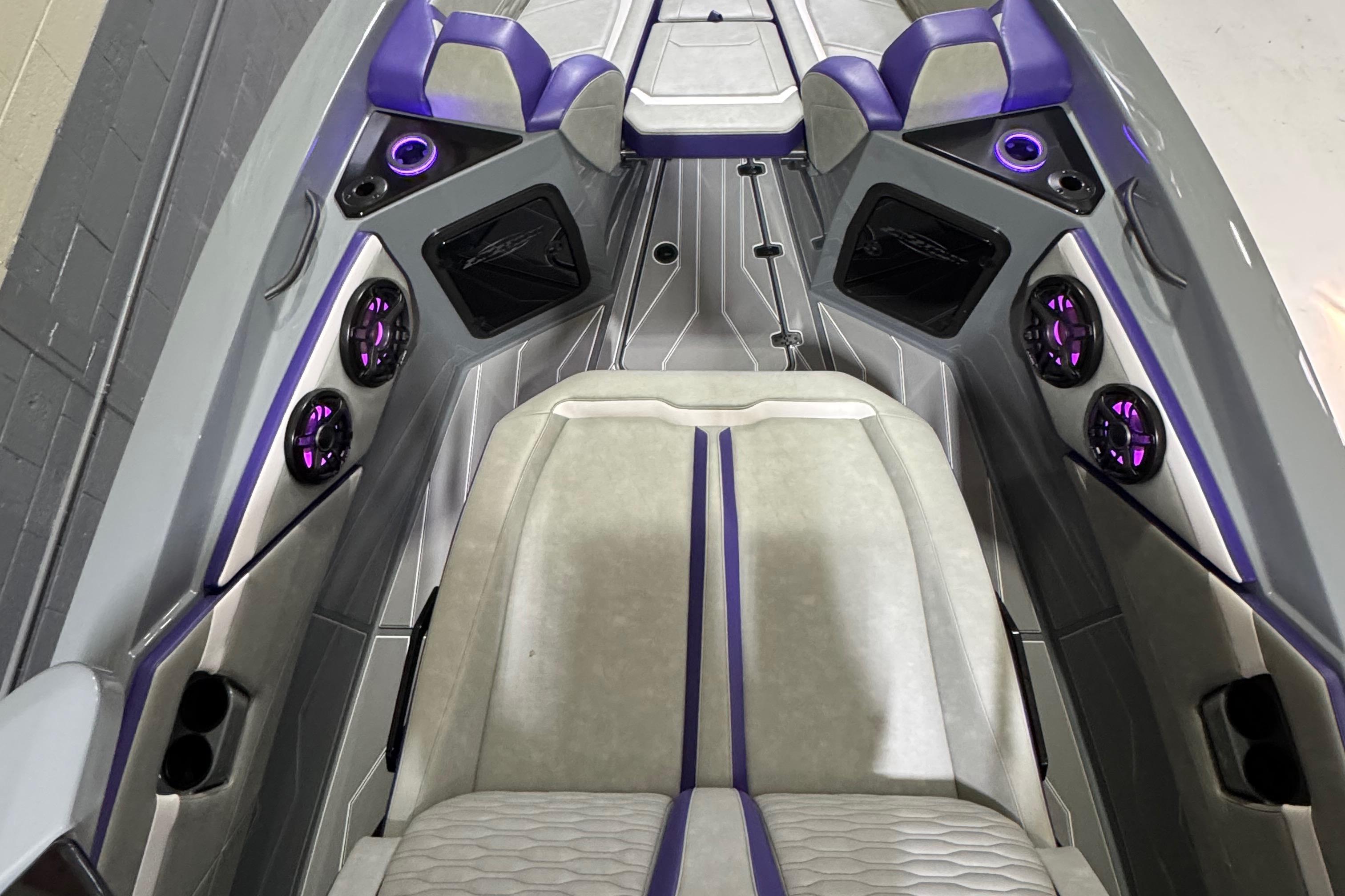 2026 Sunsation 32 CCX boat interior with purple accents and modern seating design.