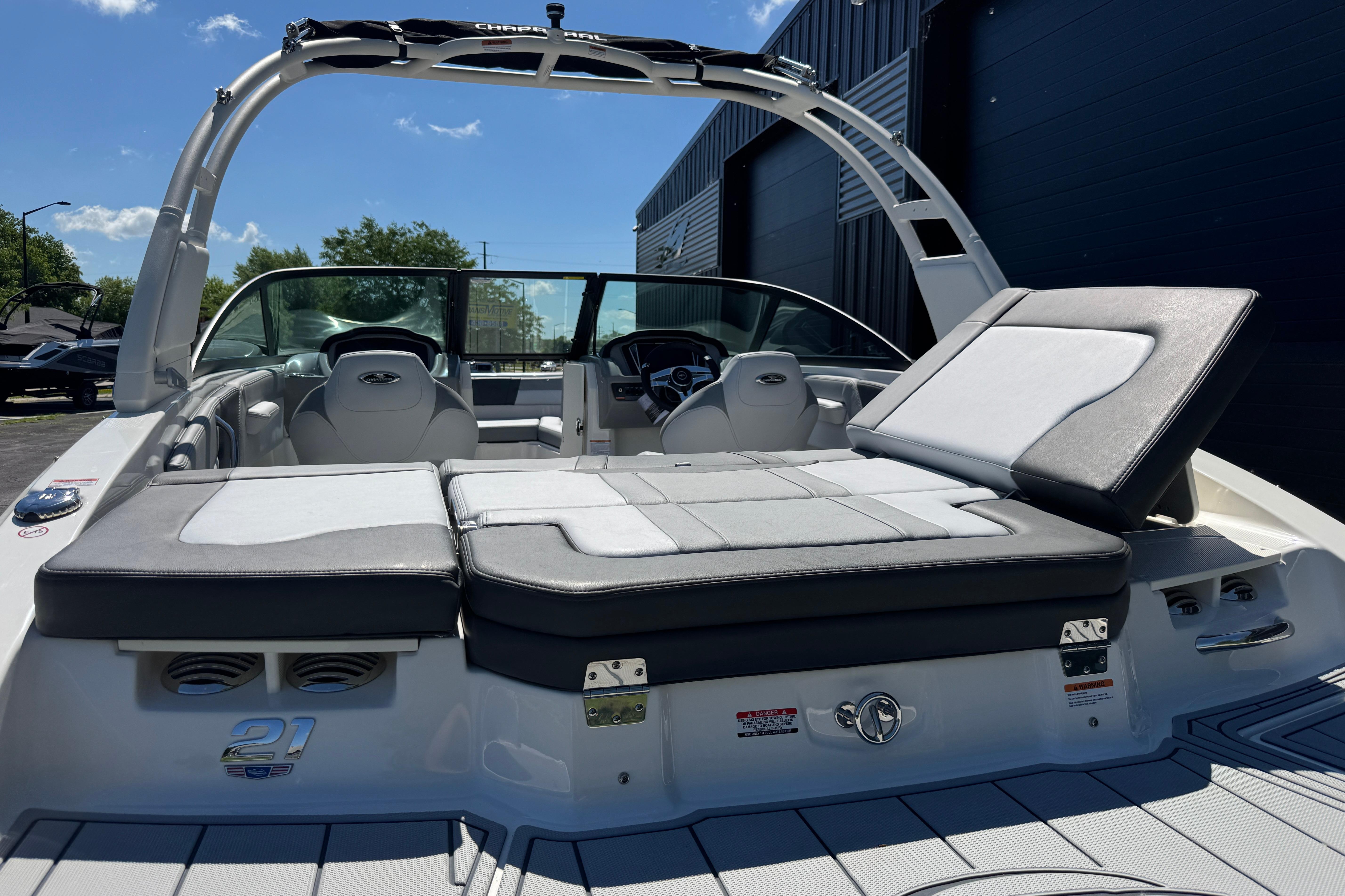 2026 Chaparral 21 SSi boat with sleek seating and modern design under clear skies.