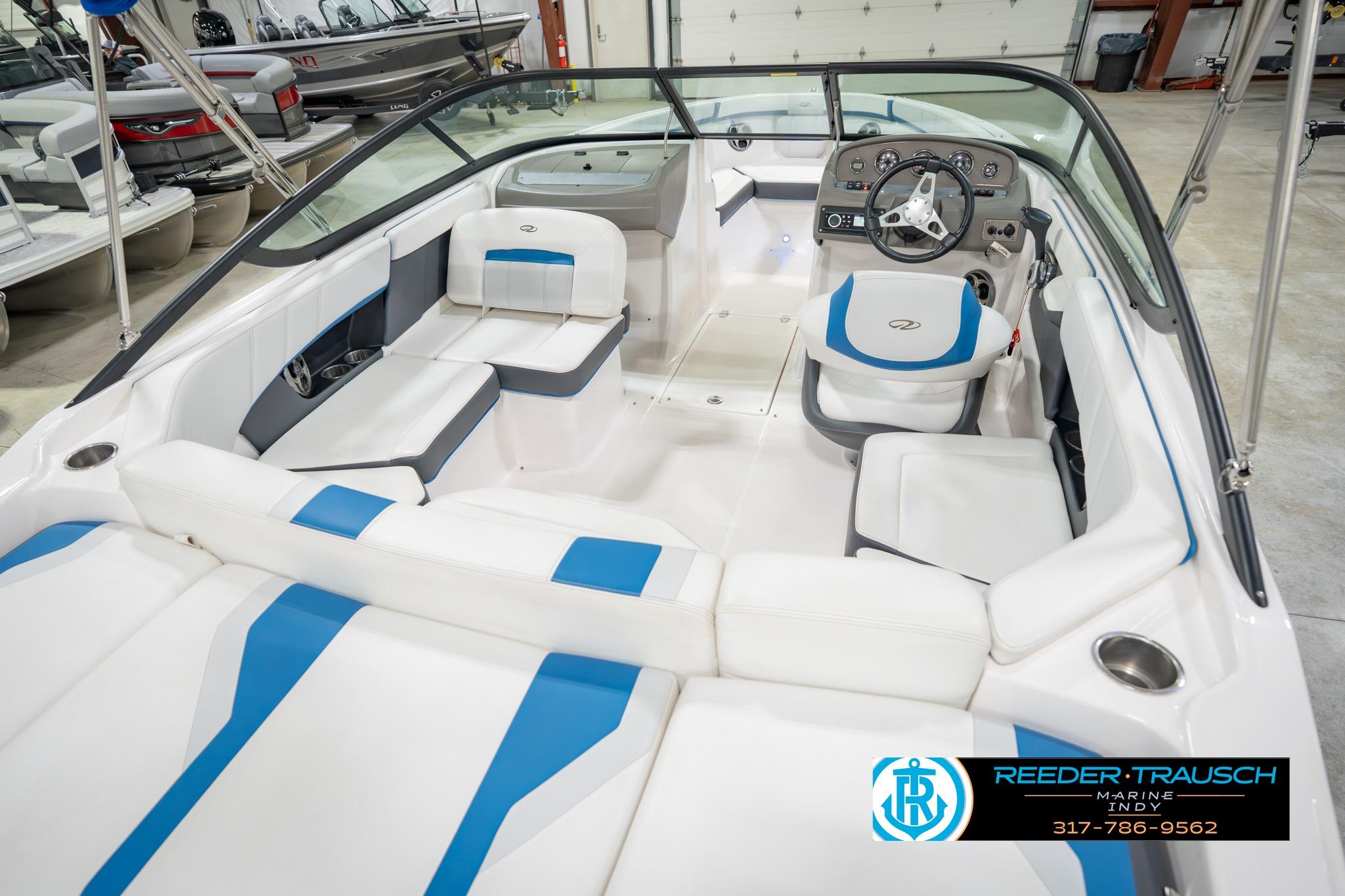 2015 Regal 2000 ESX Bowrider interior with white and blue seating, steering wheel, and dashboard.