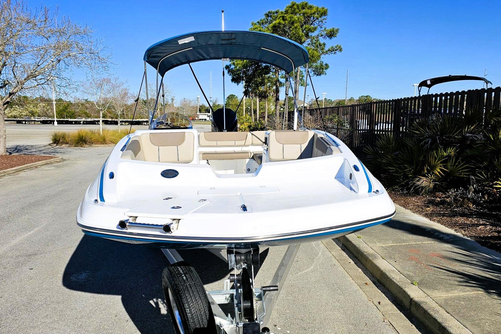 2026 Tahoe 2150 boat with canopy on trailer in sunny outdoor setting.