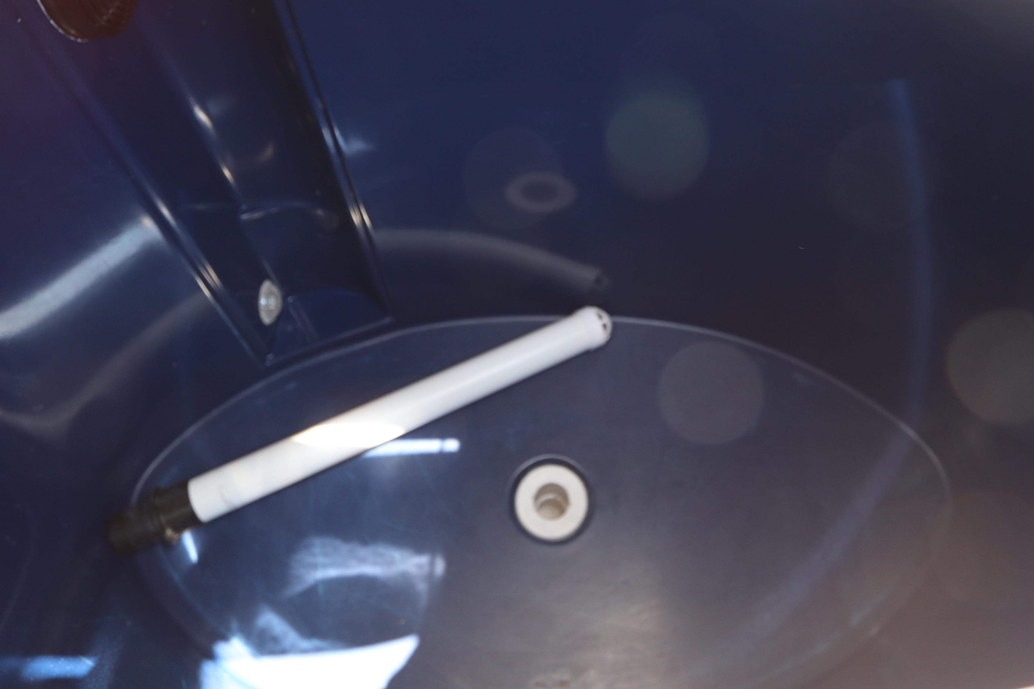 Interior of a 2014 Canyon Bay 2400 boat, featuring a blue compartment with a white rod.