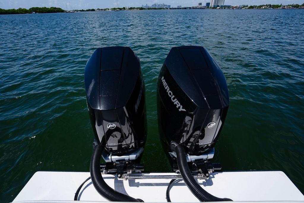 Twin Mercury outboard engines on a 2027 Reef Runner 340 boat, cruising on open water.