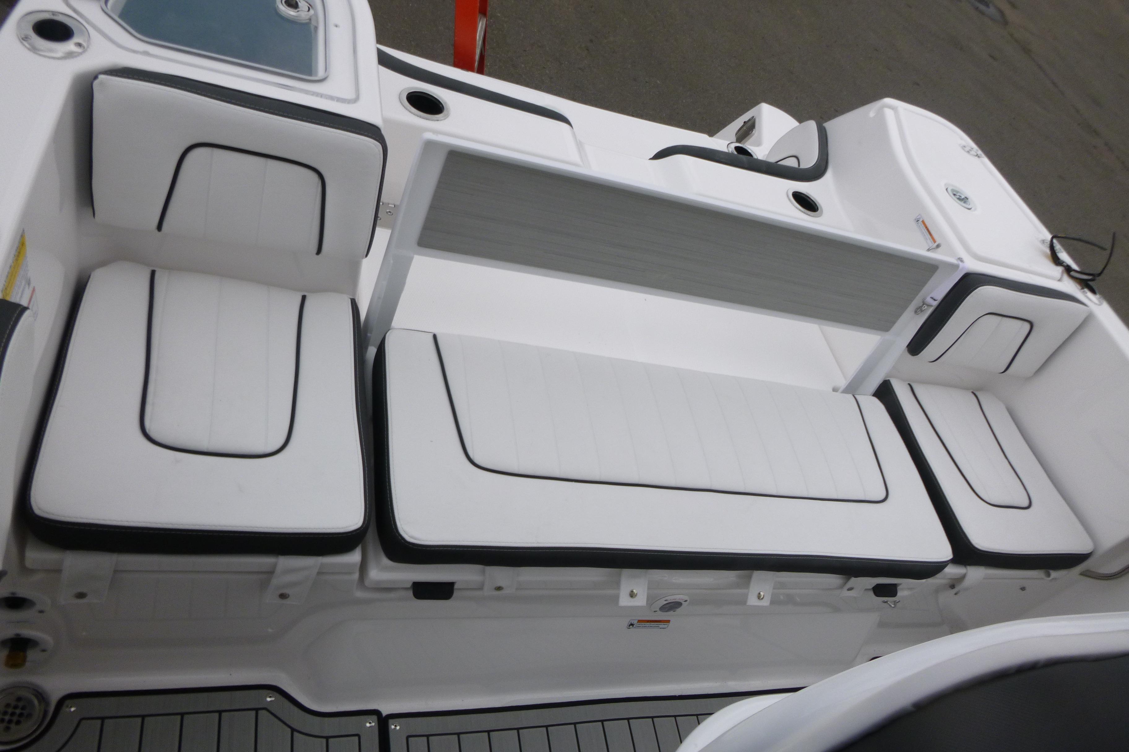 2026 Yamaha Boats 255 FSH Sport H interior seating with white cushions and black trim.