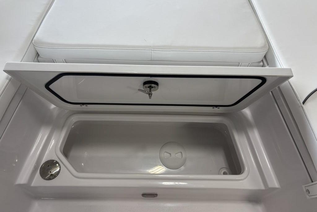 Storage compartment on a 2026 Sportsman Masters 247 Bay Boat, featuring a cushioned lid.