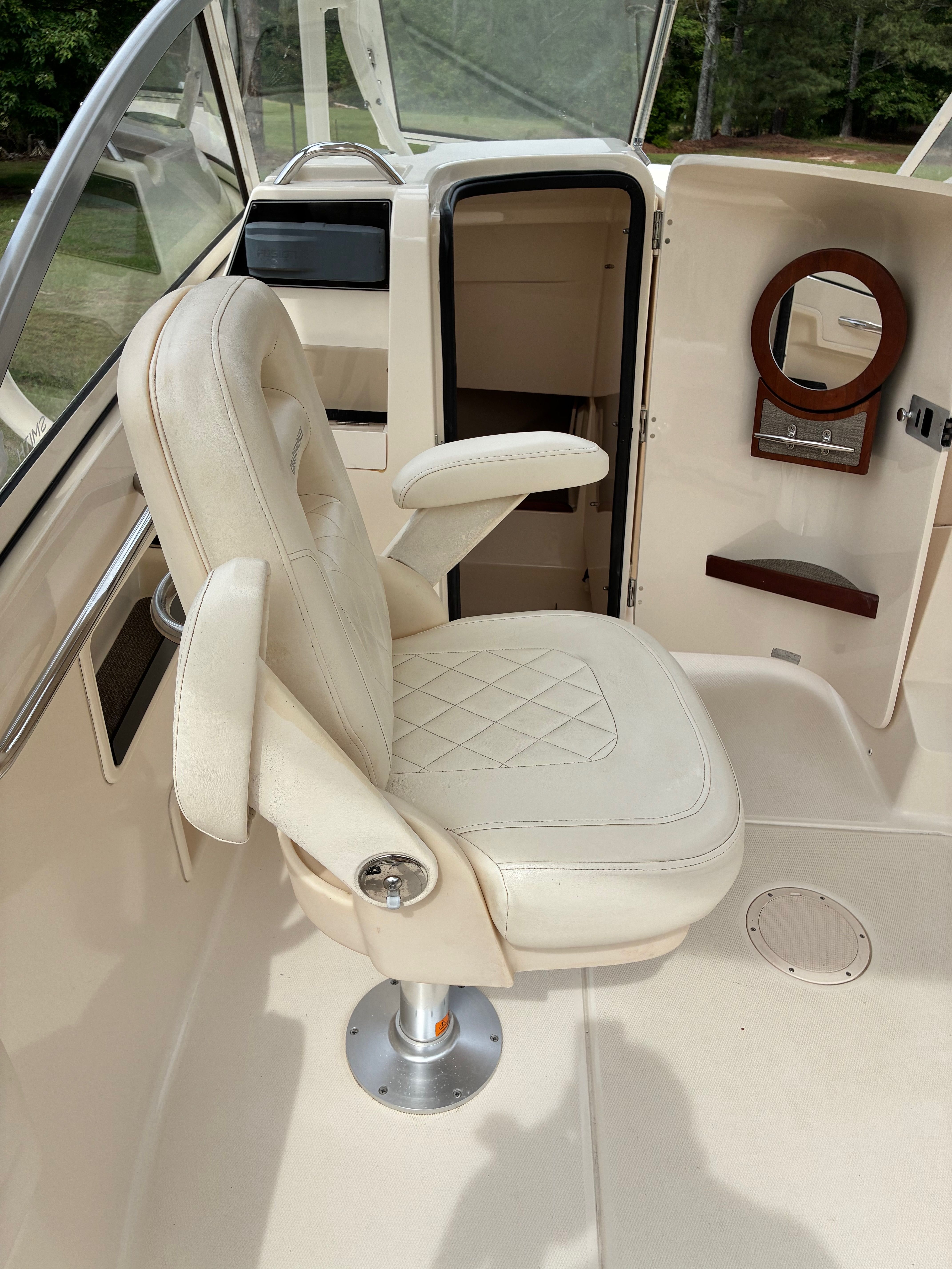 Interior of a 2018 Grady-White Freedom 235 boat with beige seating.