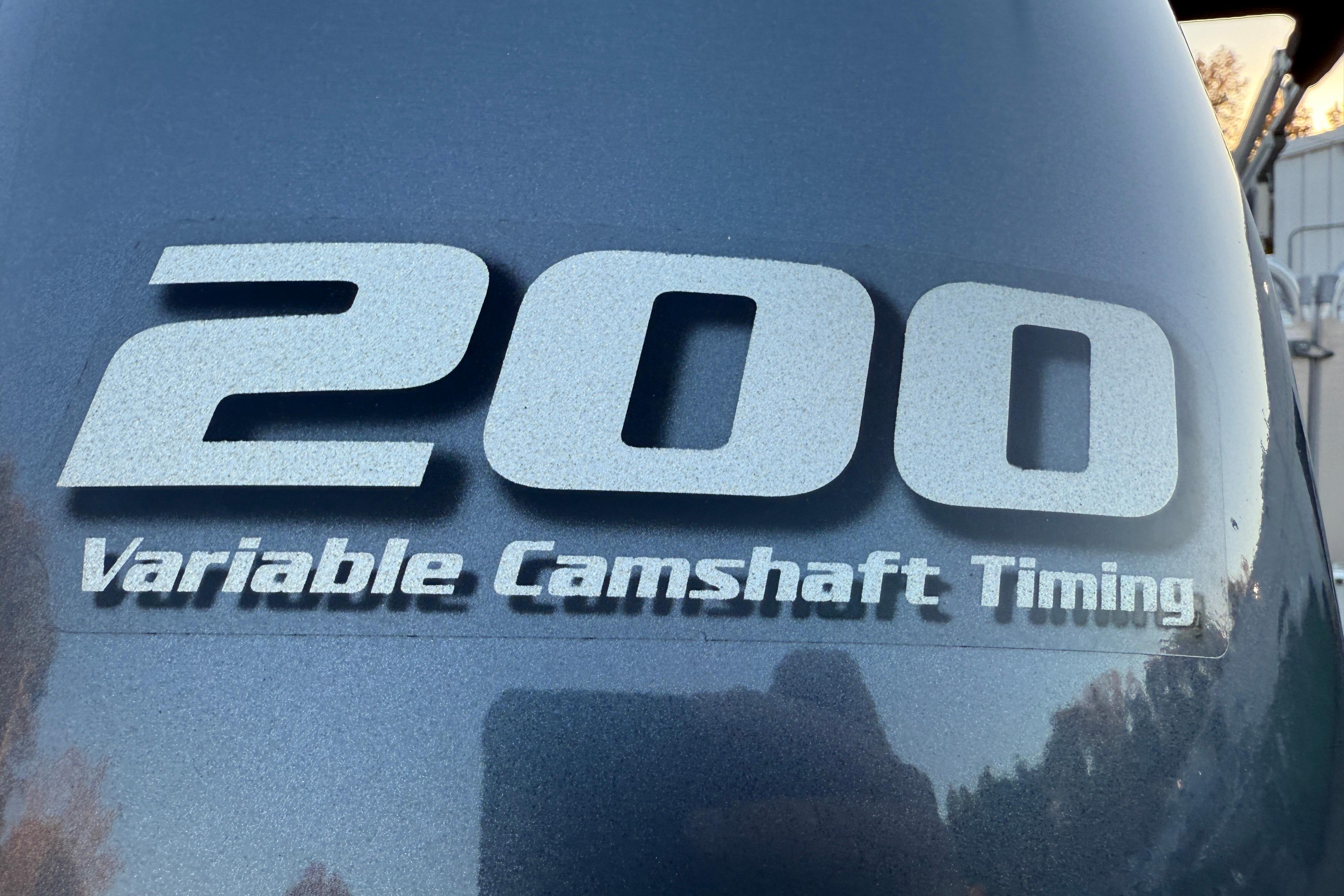 Close-up of 2011 Tahoe Pontoon 2485 DRL engine with '200 Variable Camshaft Timing' label.