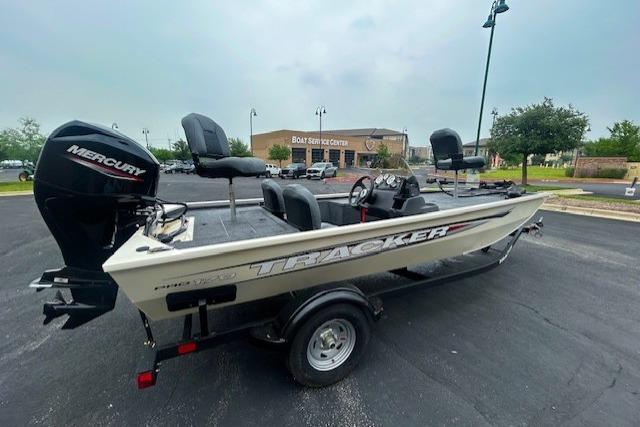 2026 Tracker Pro 170 fishing boat with Mercury engine in parking lot.