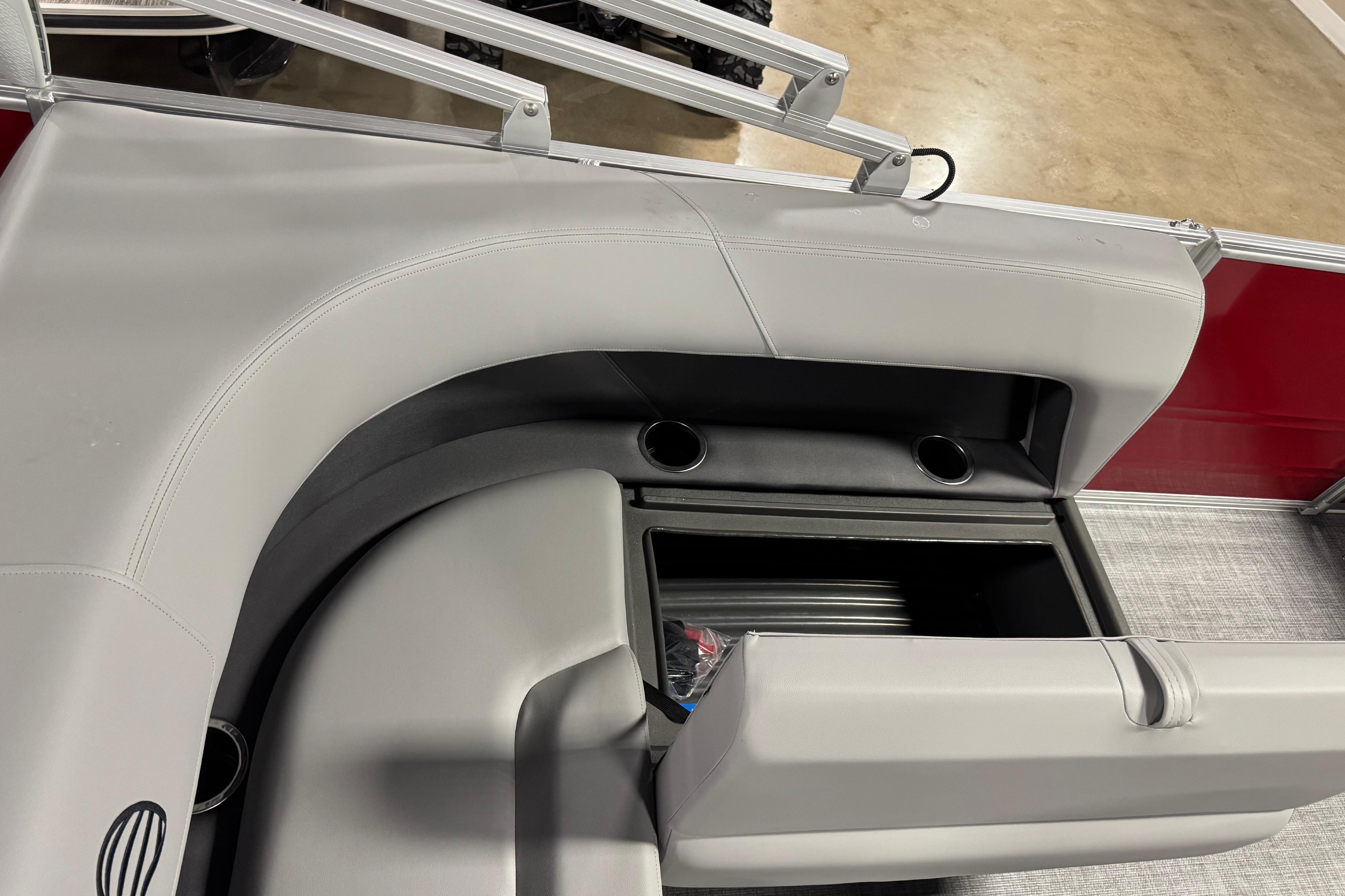 2026 Sun Tracker Party Barge 18 DLX interior with storage and cup holders.