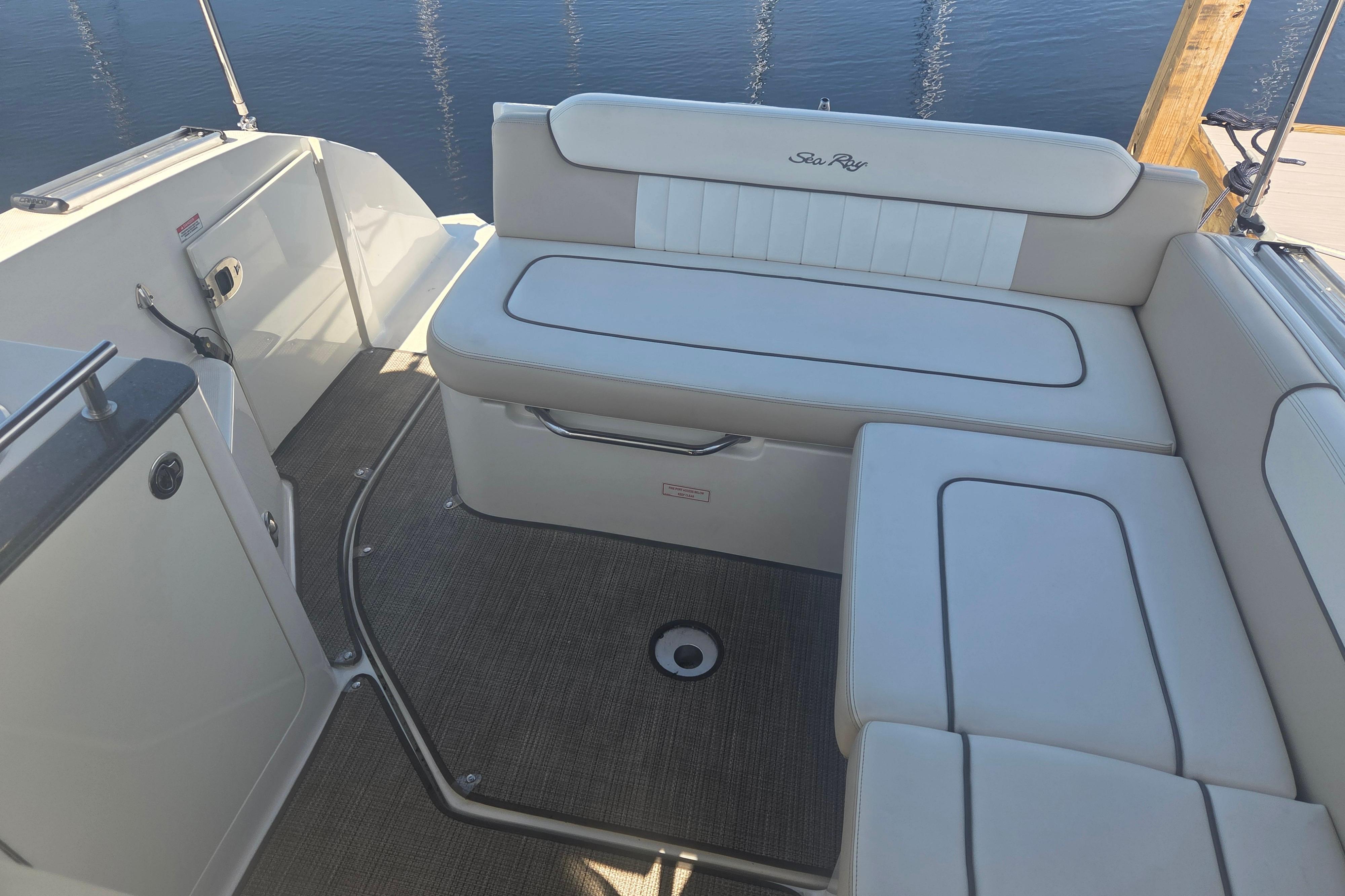 2012 Sea Ray Sundancer 260 boat interior with cushioned seating and carpeted floor.