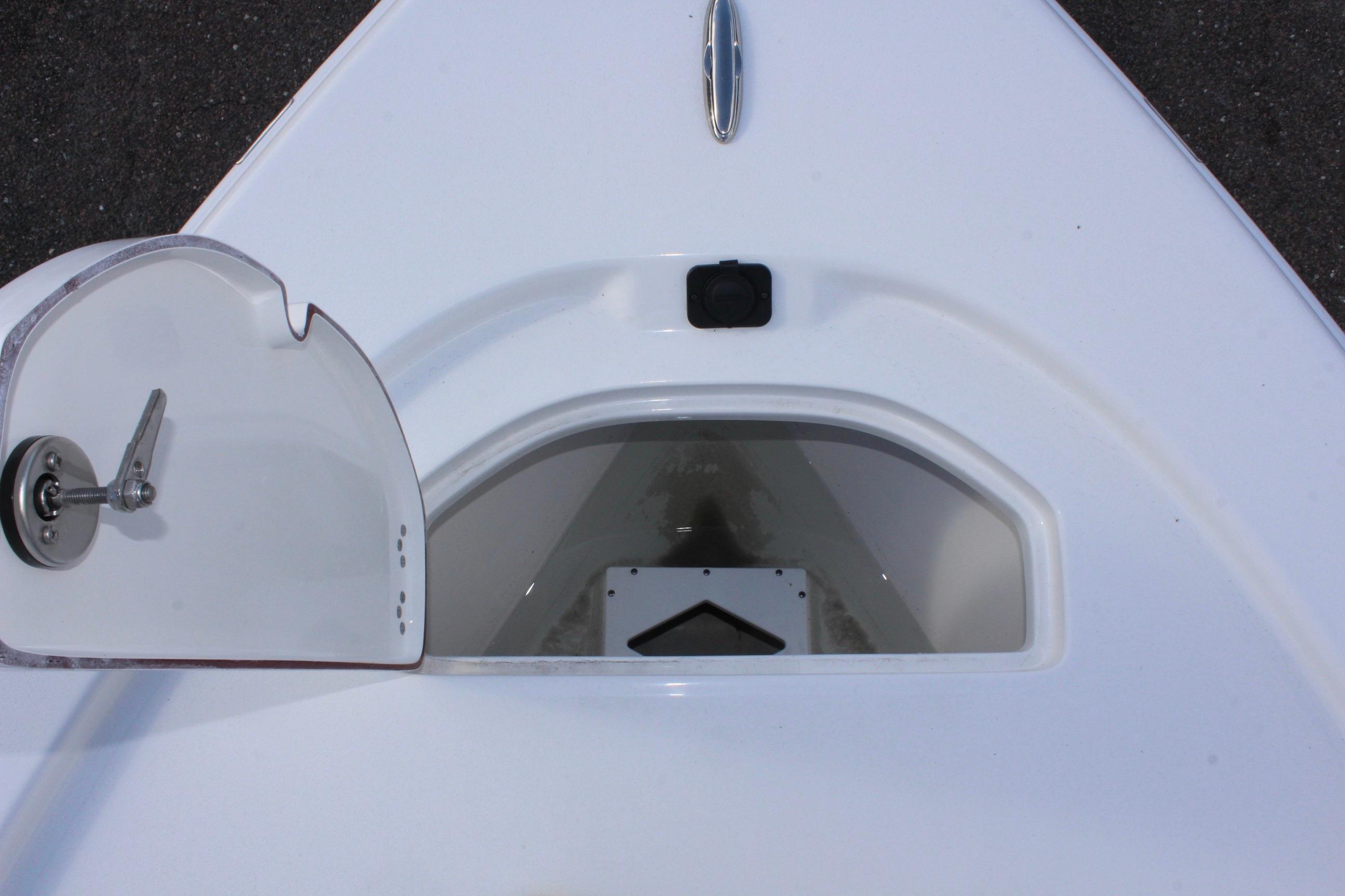 Open storage compartment on 2025 Sea Pro 230 Bay boat deck.