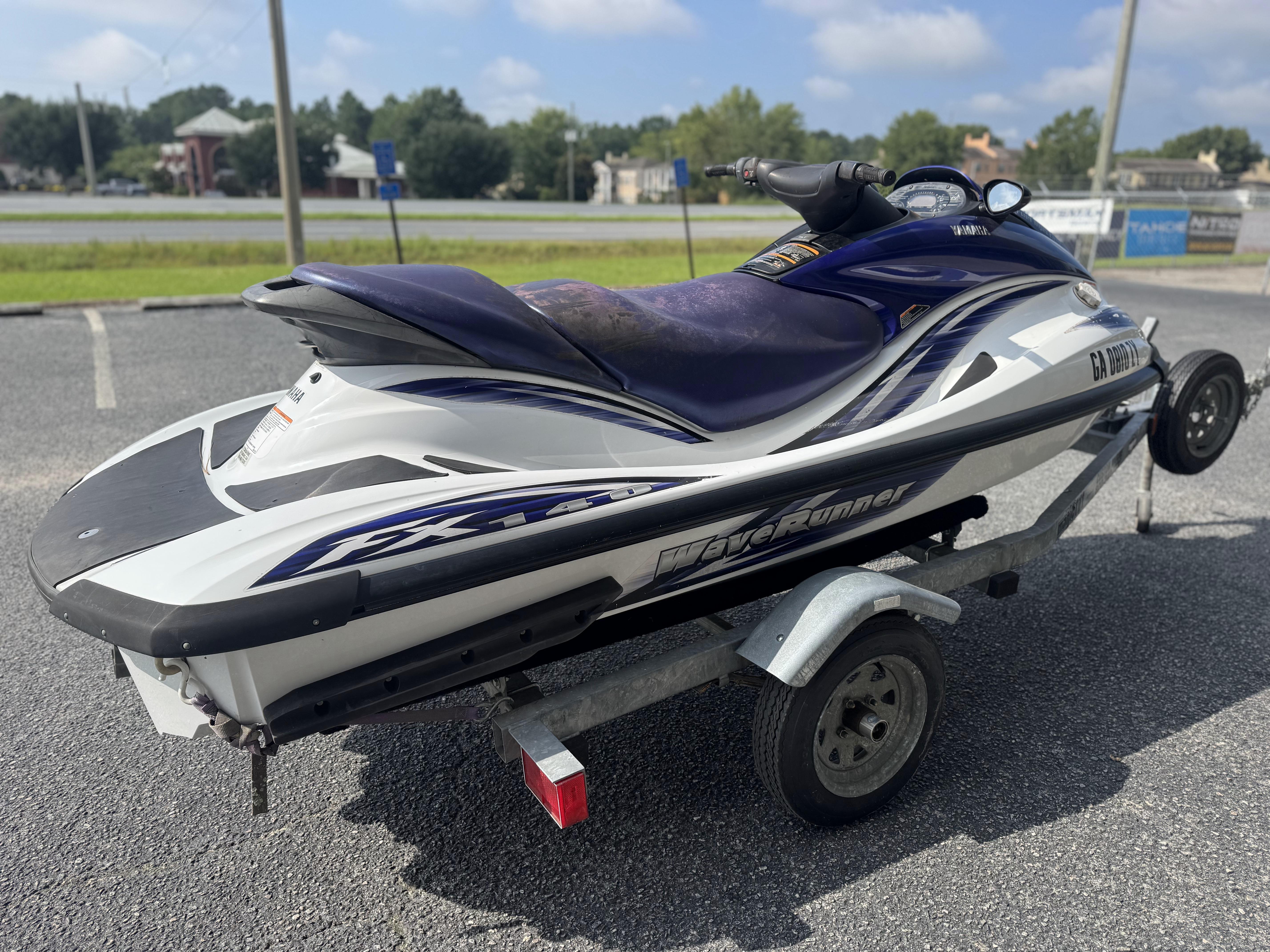 2003 Yamaha WaveRunner FX140 on trailer in parking lot.