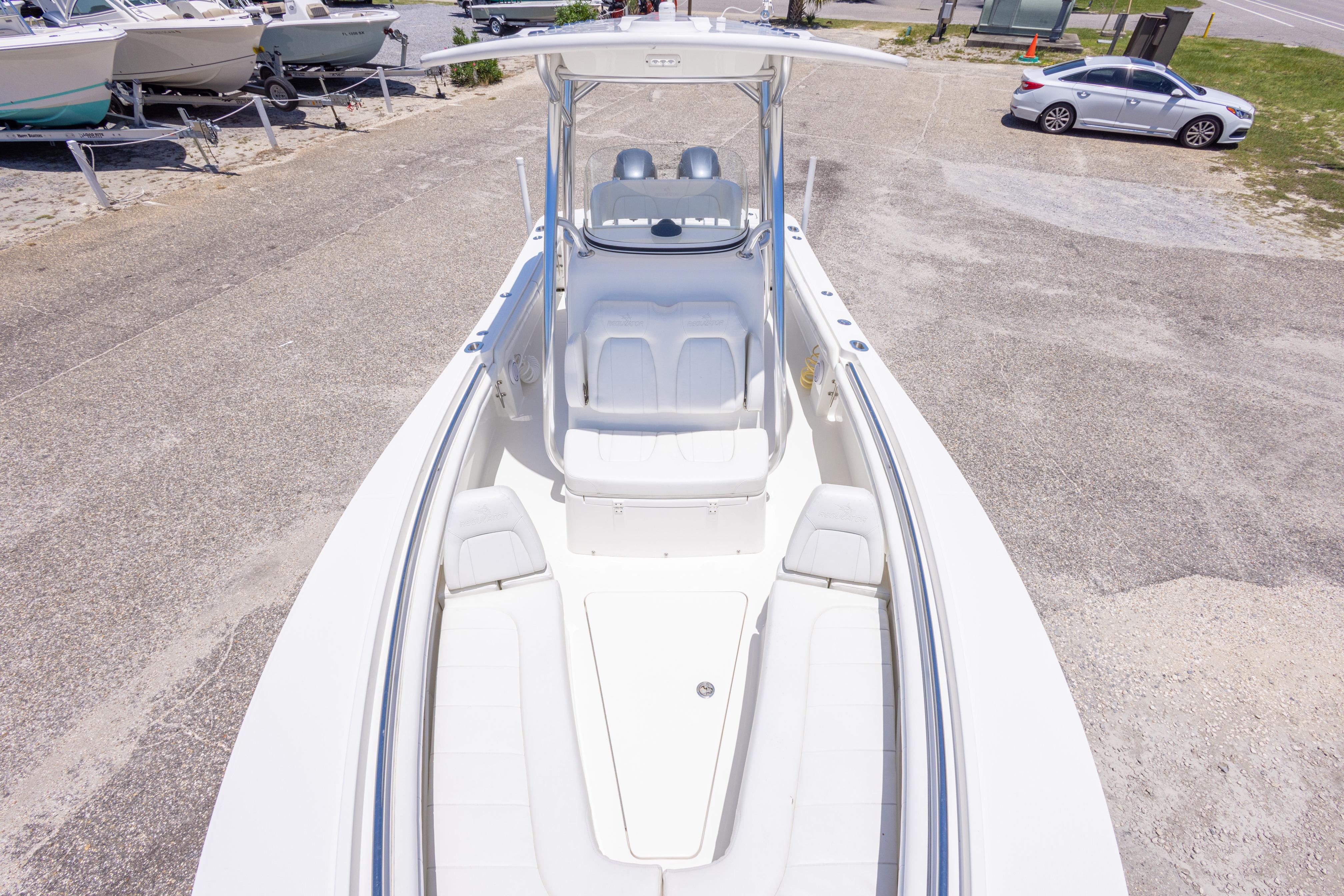 2019 Regulator 23 Center Console boat on a sunny day at a marina.