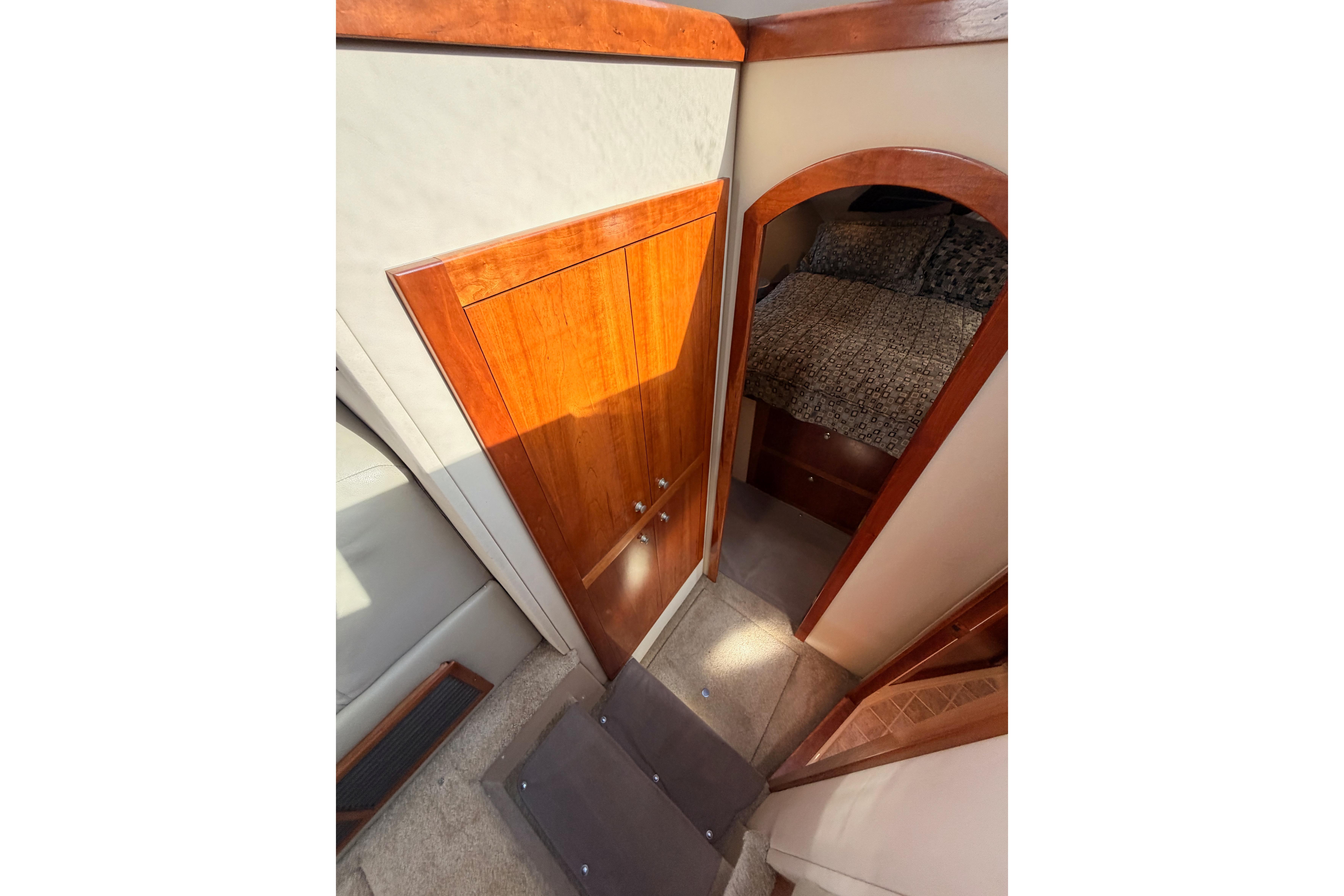 Interior view of 2005 Cruisers Yachts 405 Express Motoryacht, featuring wooden doors and cozy cabin.
