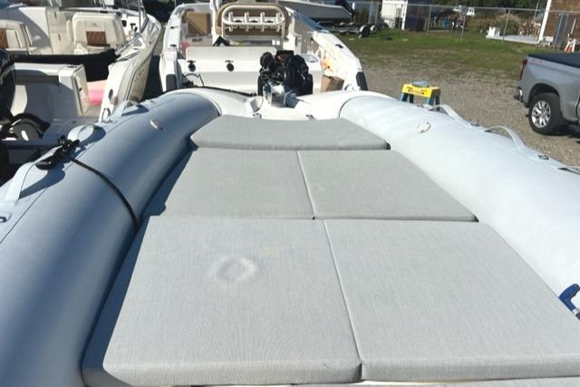 2023 Zodiac N-ZO 680 boat with cushioned deck, parked outdoors.