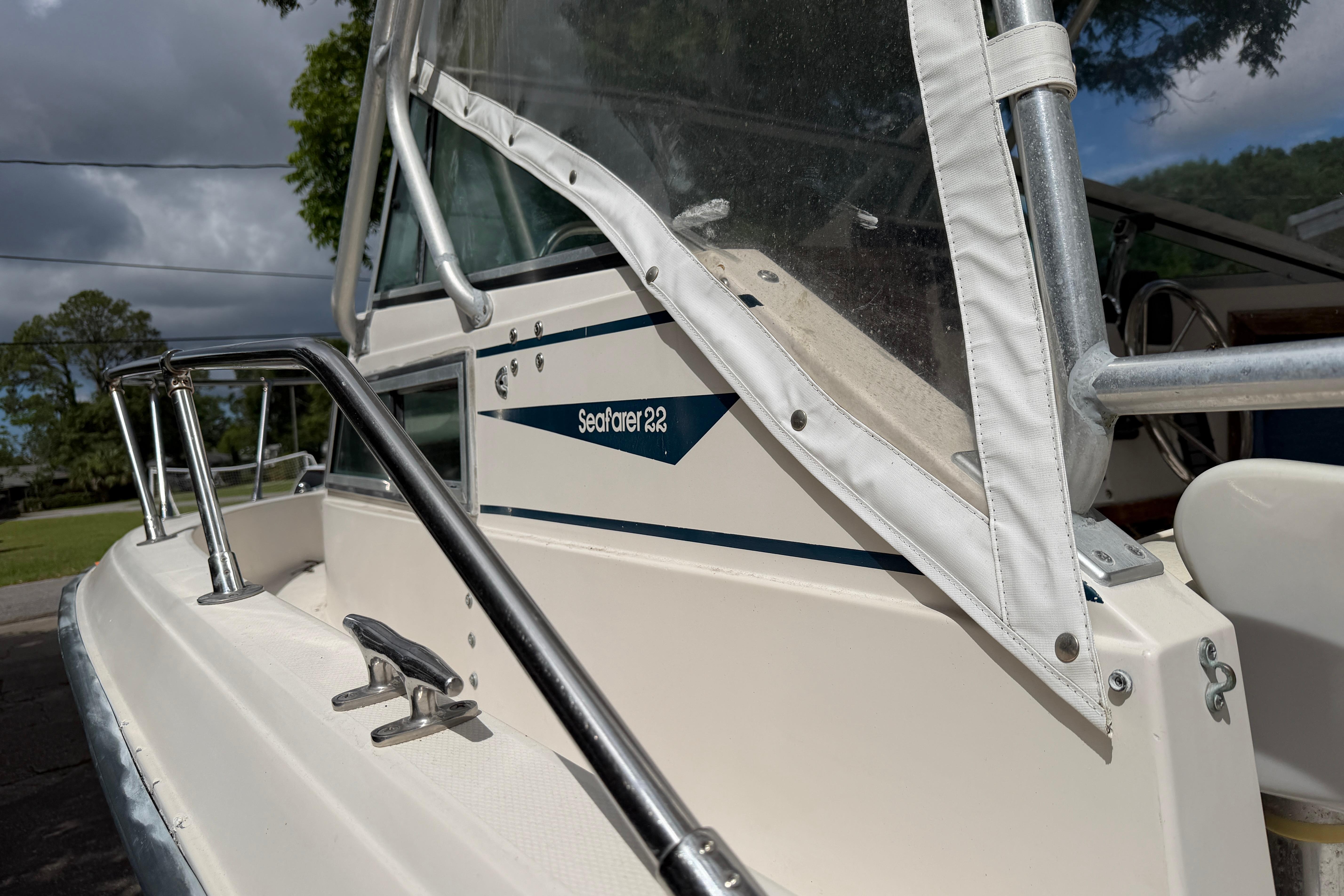 1987 Grady-White Seafarer 226 boat, close-up of side and railing under cloudy sky.