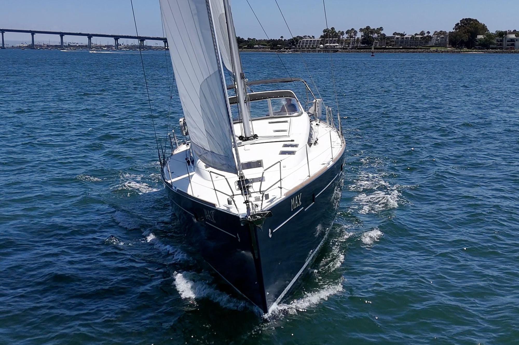2017 Beneteau Sense 50 sailboat cruising on open water near a bridge.