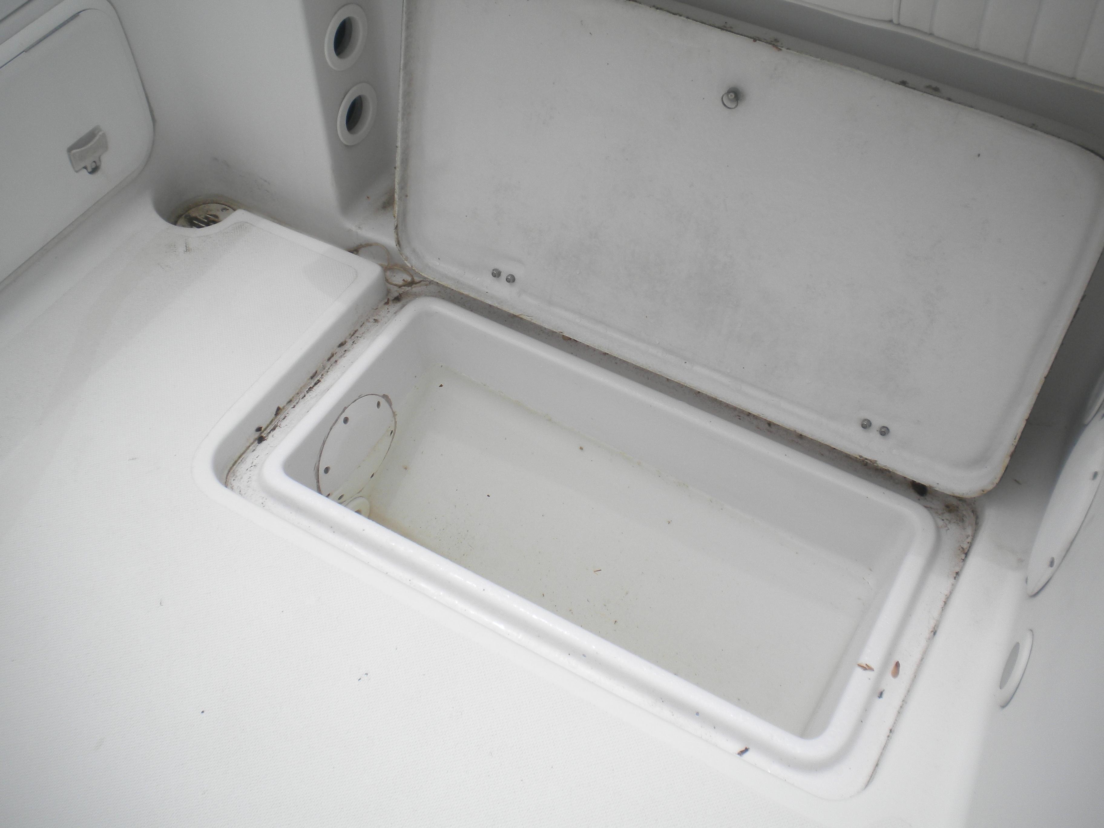 Open storage compartment on a 2003 Pro-Line 23 Walk boat.