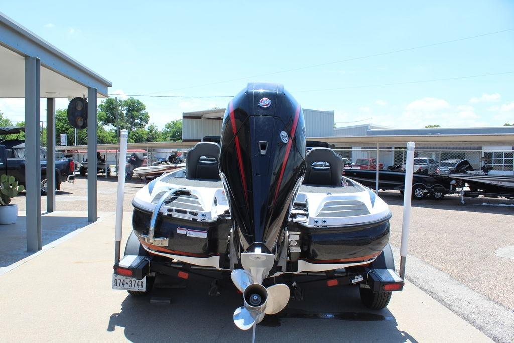 2007 Skeeter 21i boat with powerful outboard motor, parked outdoors on a sunny day.