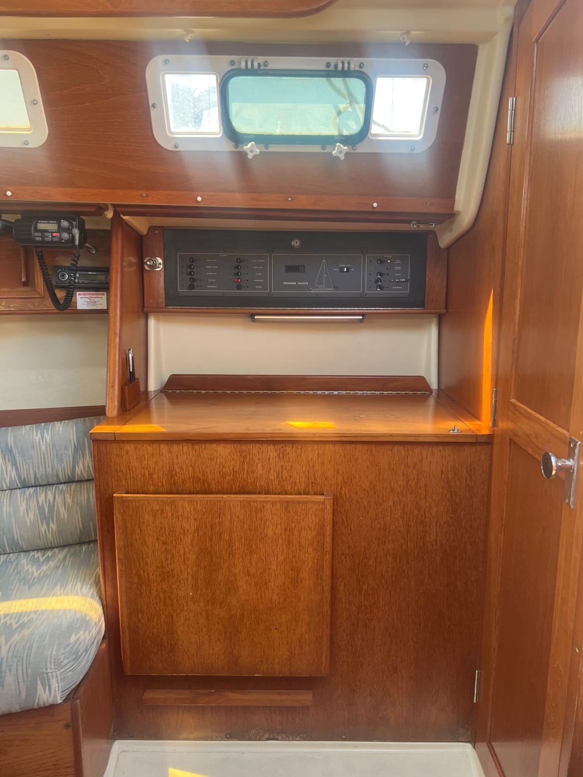 Interior of a 1988 Pearson 28 with wooden cabinetry and a window.