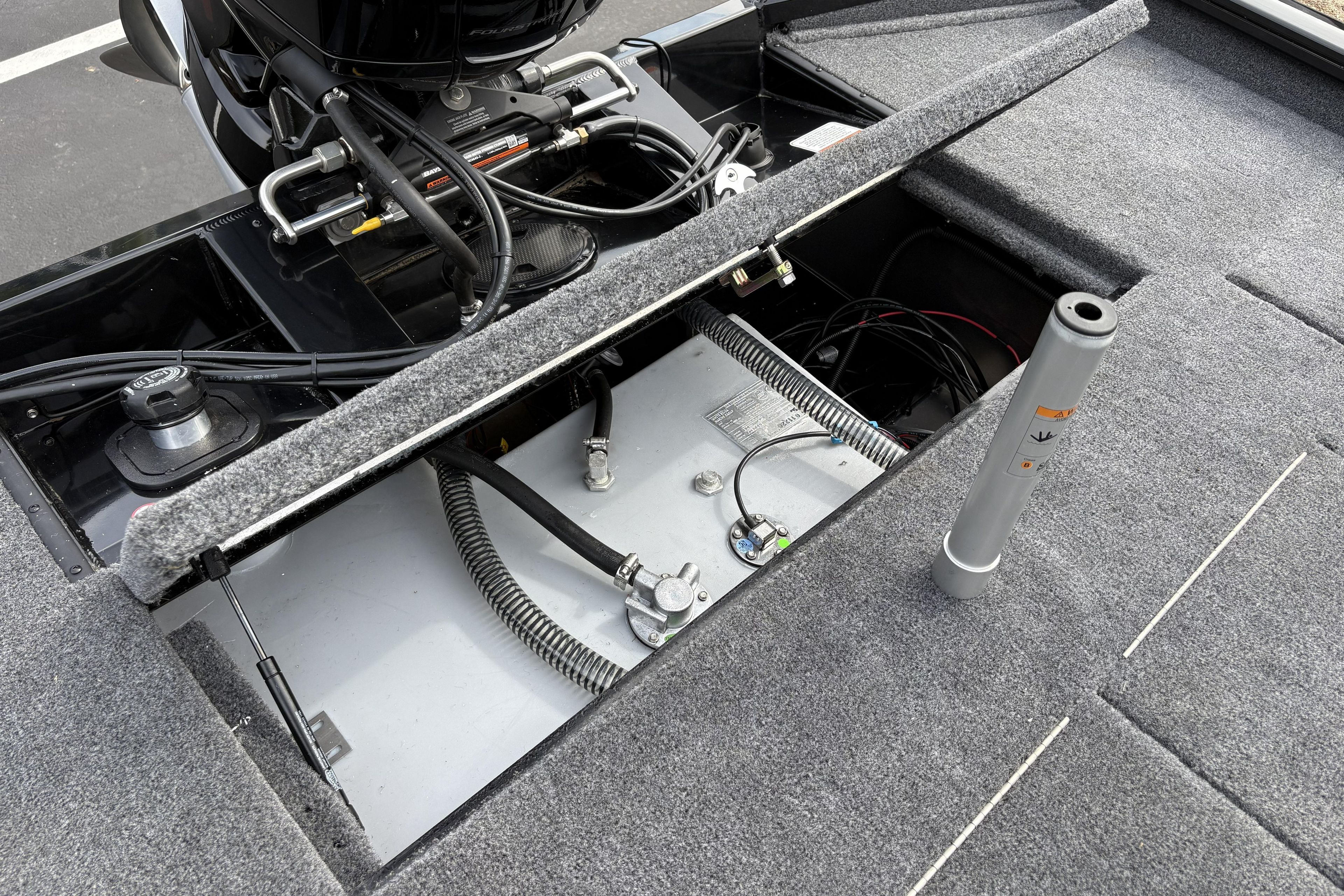 Open compartment of 2026 Tracker Pro Team 195 boat showing engine and wiring.