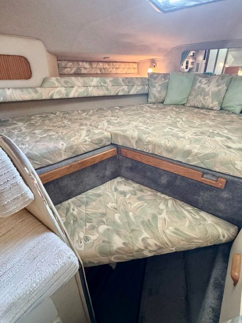 Interior of a 1992 Sea Ray 290 Sundancer with cushioned seating and pillows.
