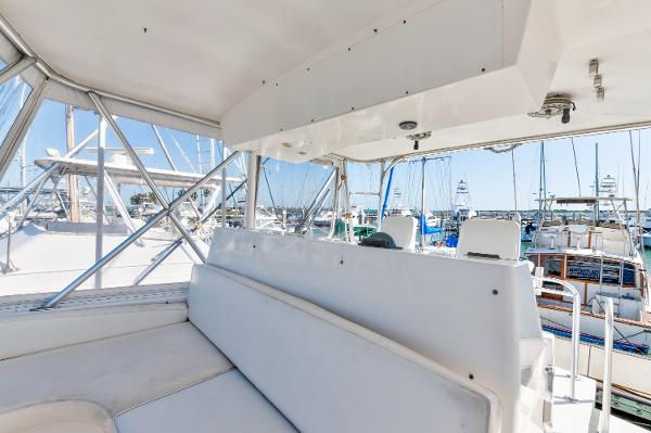 1999 Viking 47 Convertible yacht interior with white seating and marina view.