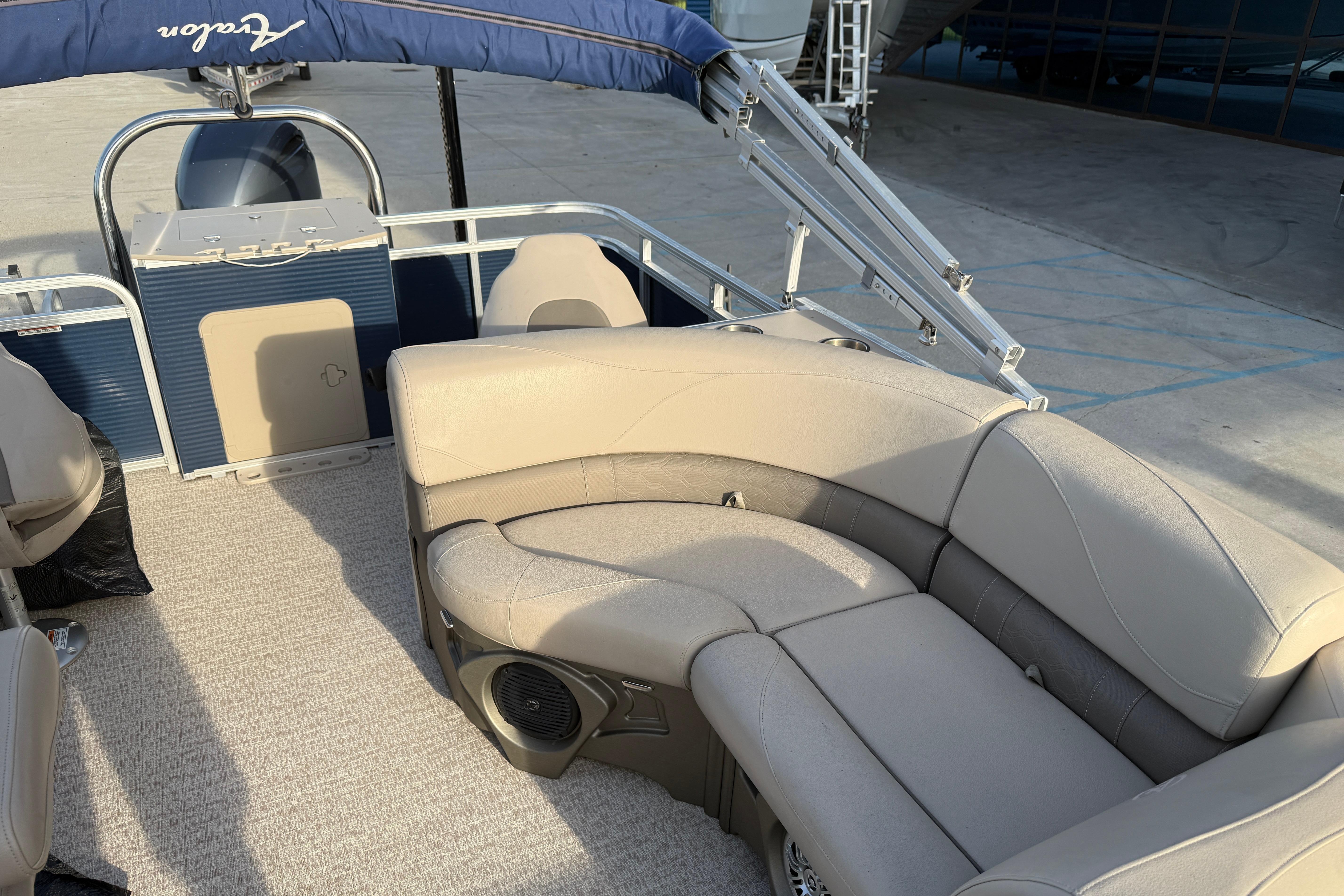 2019 Avalon Venture Fish N Cruise 20' pontoon boat with beige seating and blue canopy.