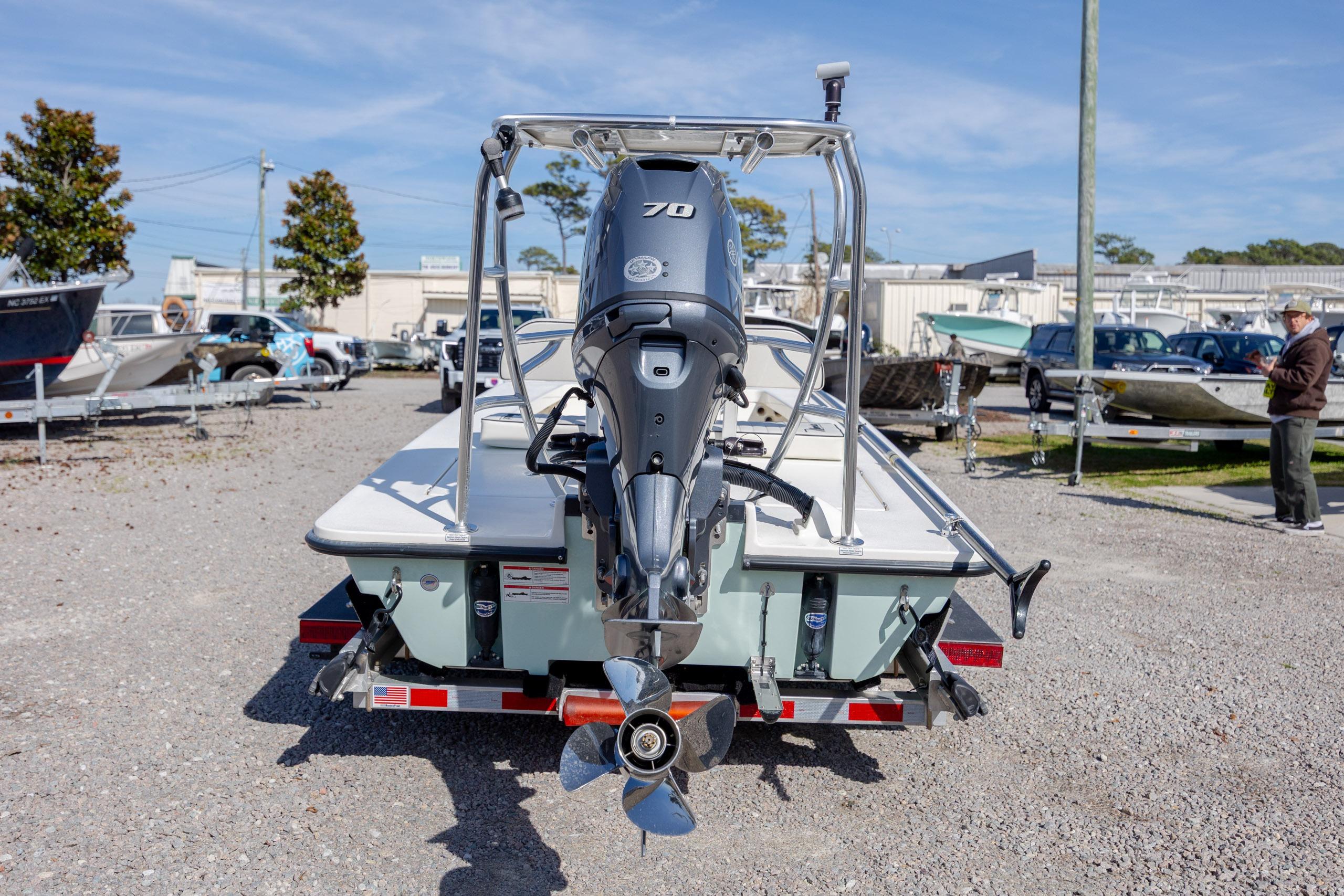 2024 Maverick 17 HPX-S boat with outboard motor in a marina setting.