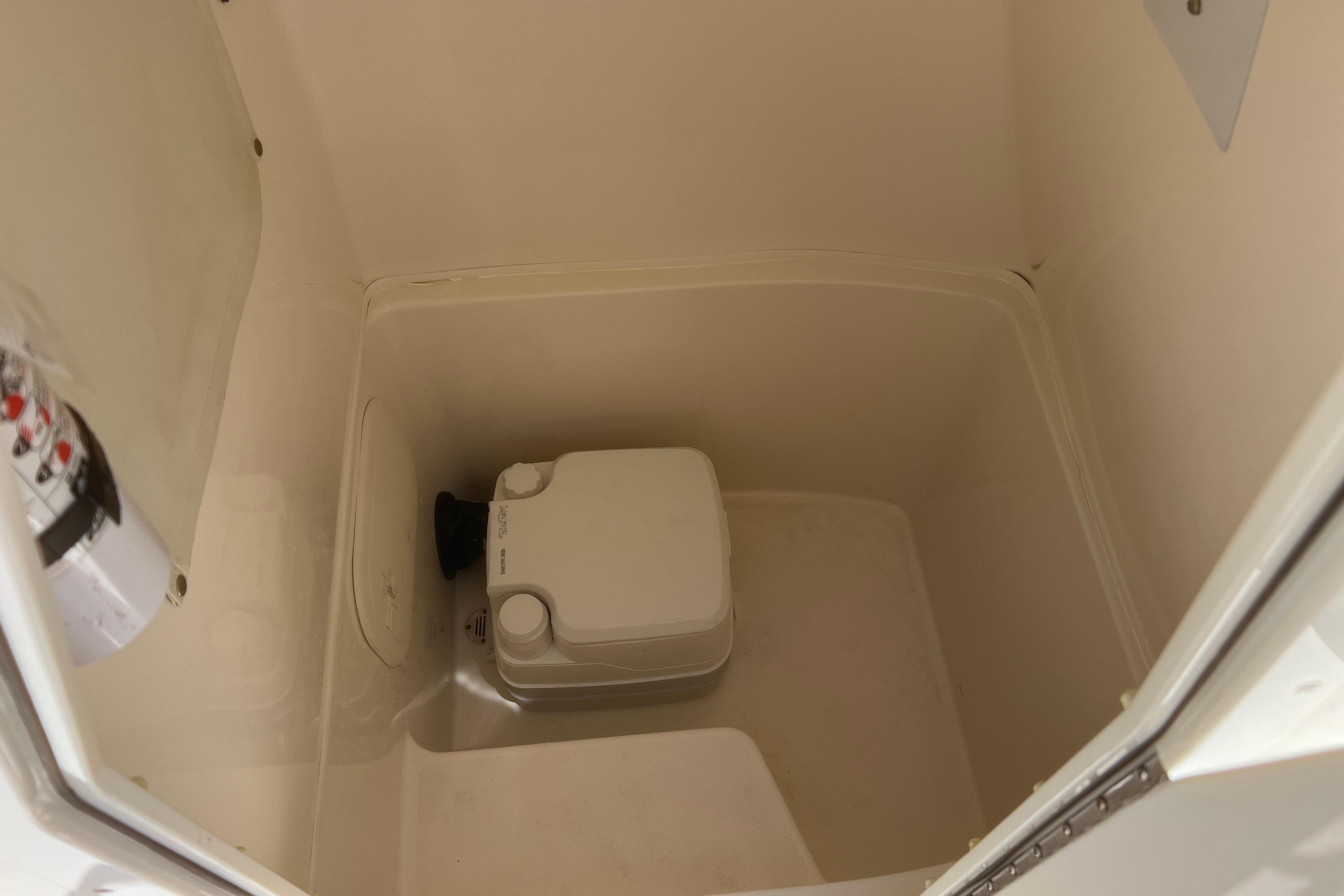 Interior of 2018 Cobia 201 Center Console boat showing storage compartment.