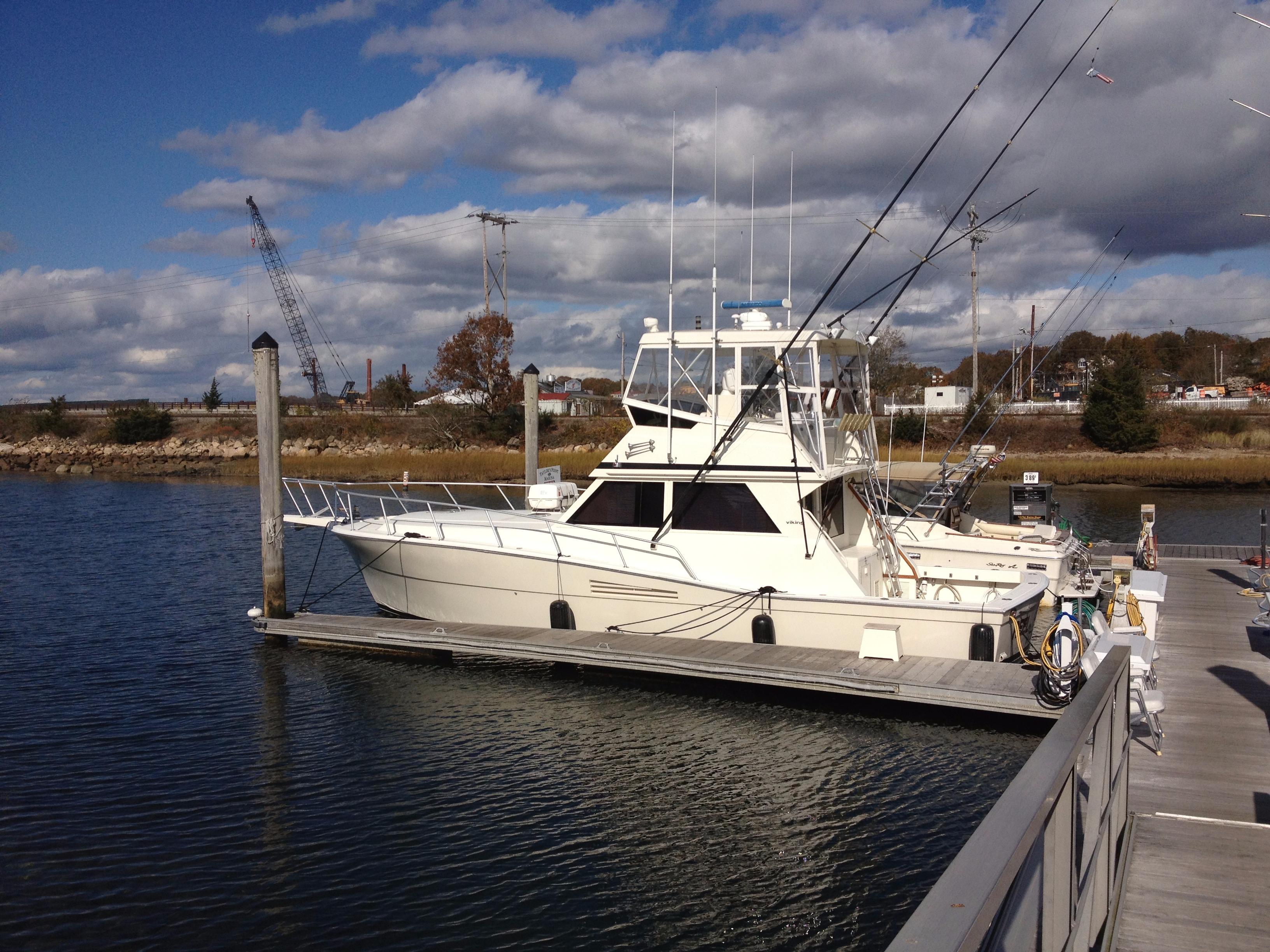 1989 Viking 41 Sportfish Convertible docked, serene water setting.