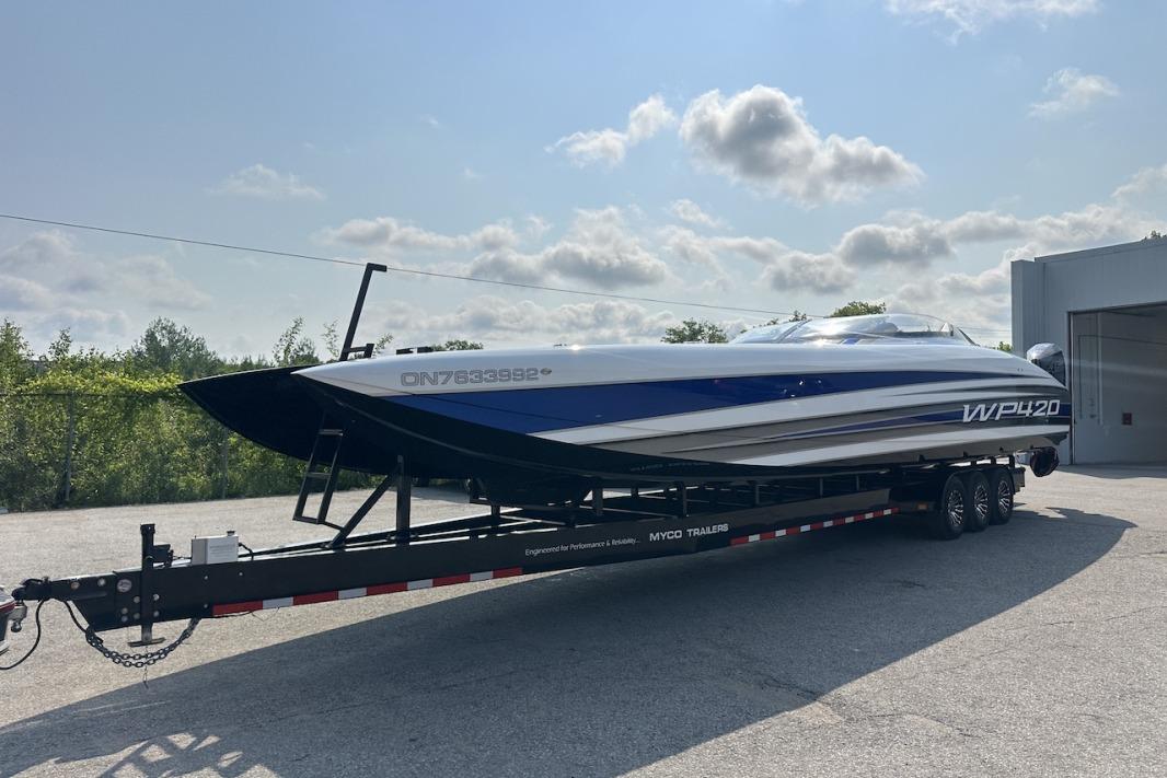 2018 Wright Performance 420 boat on trailer under cloudy sky.