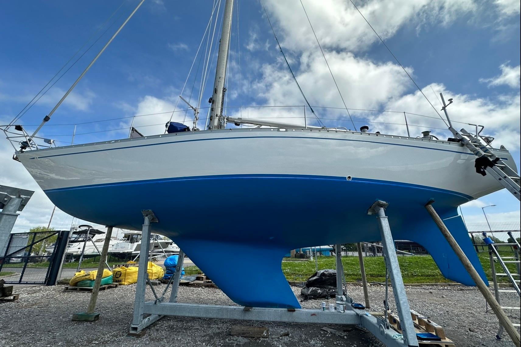 1974 Nautor Swan 41 sailboat on dry dock, showcasing blue hull and sleek design.