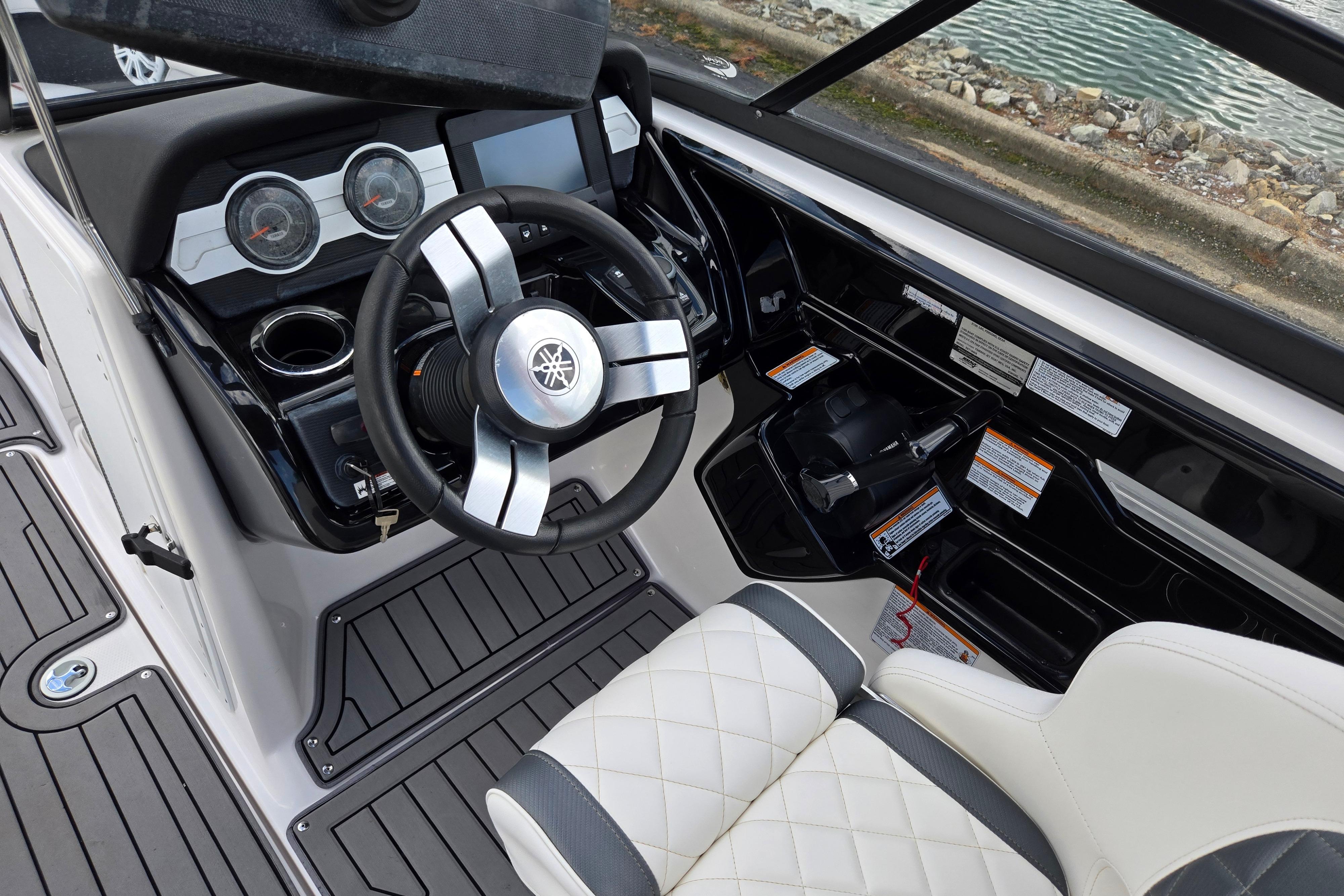 2018 Yamaha Boats 212X cockpit with steering wheel, gauges, and seating.