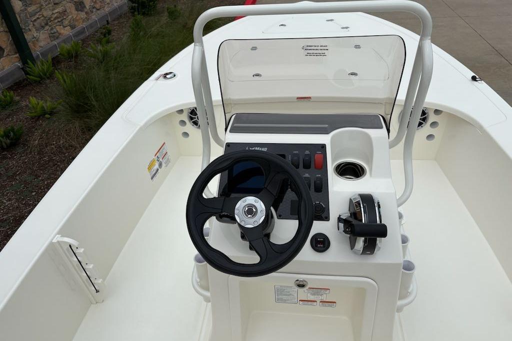 2026 Mako 18 Pro Skiff boat console with steering wheel and controls.