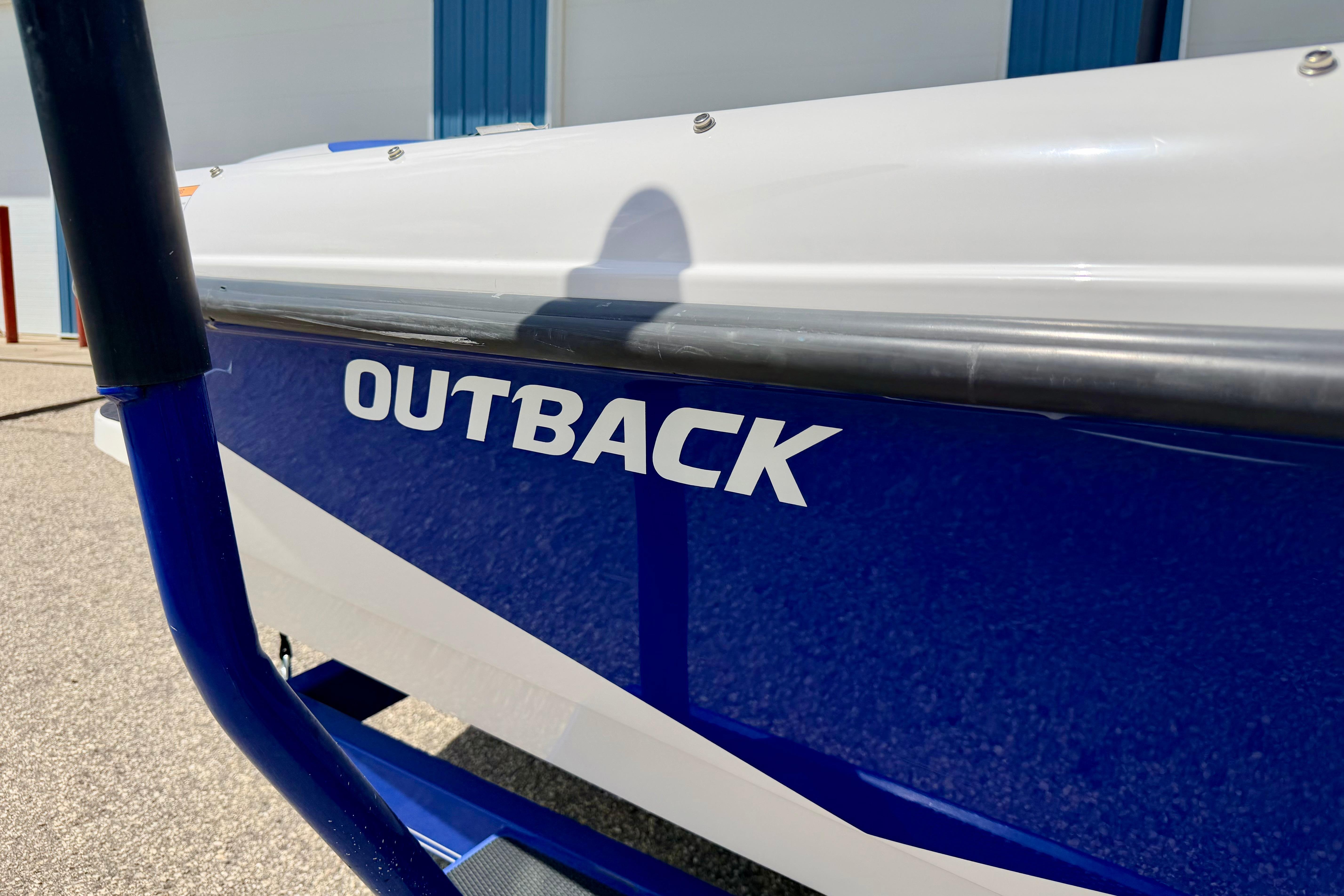 2008 Moomba Outback V boat, blue and white exterior, parked outdoors.