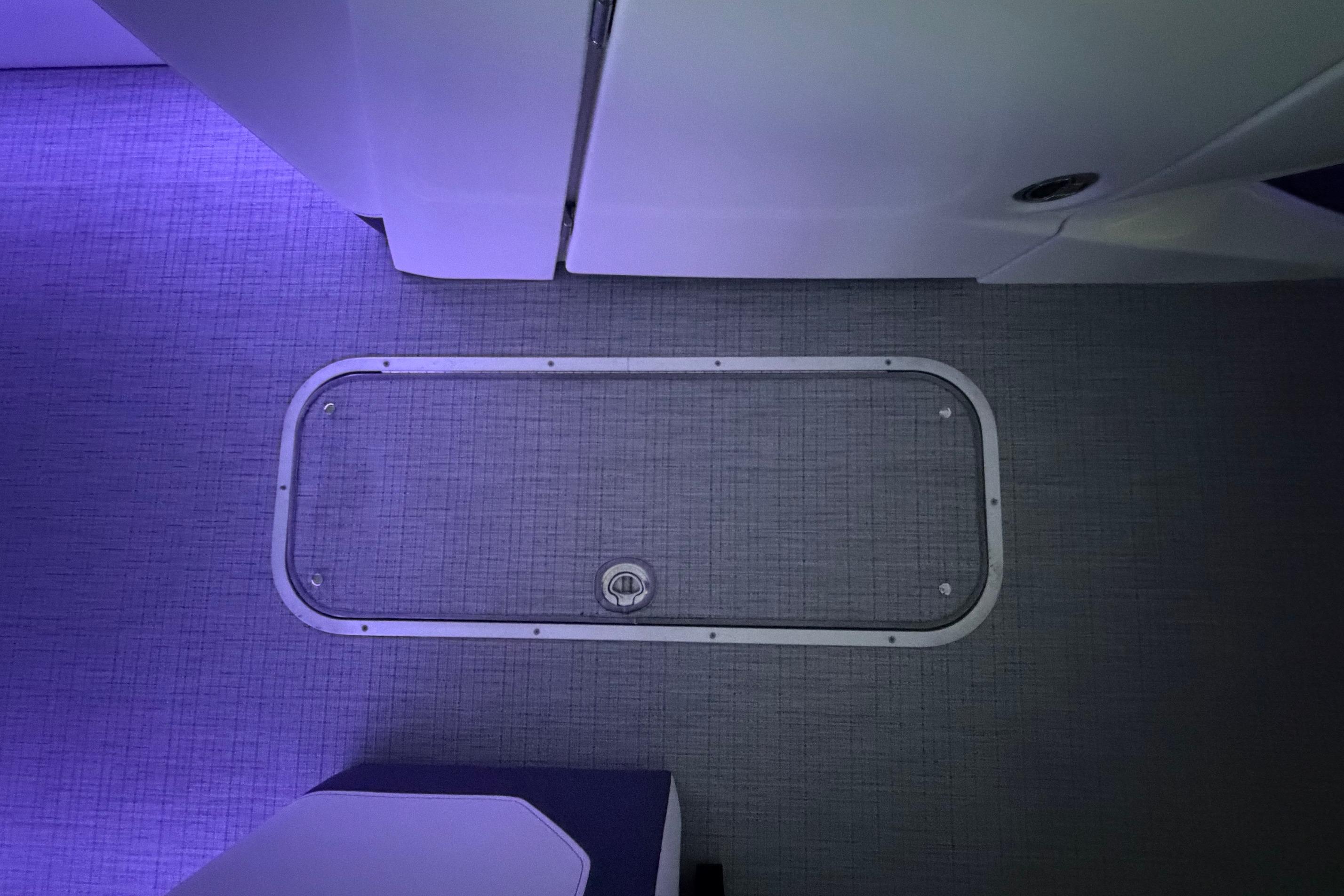 Interior view of 2026 South Bay 525SB2 boat with illuminated flooring and hatch.
