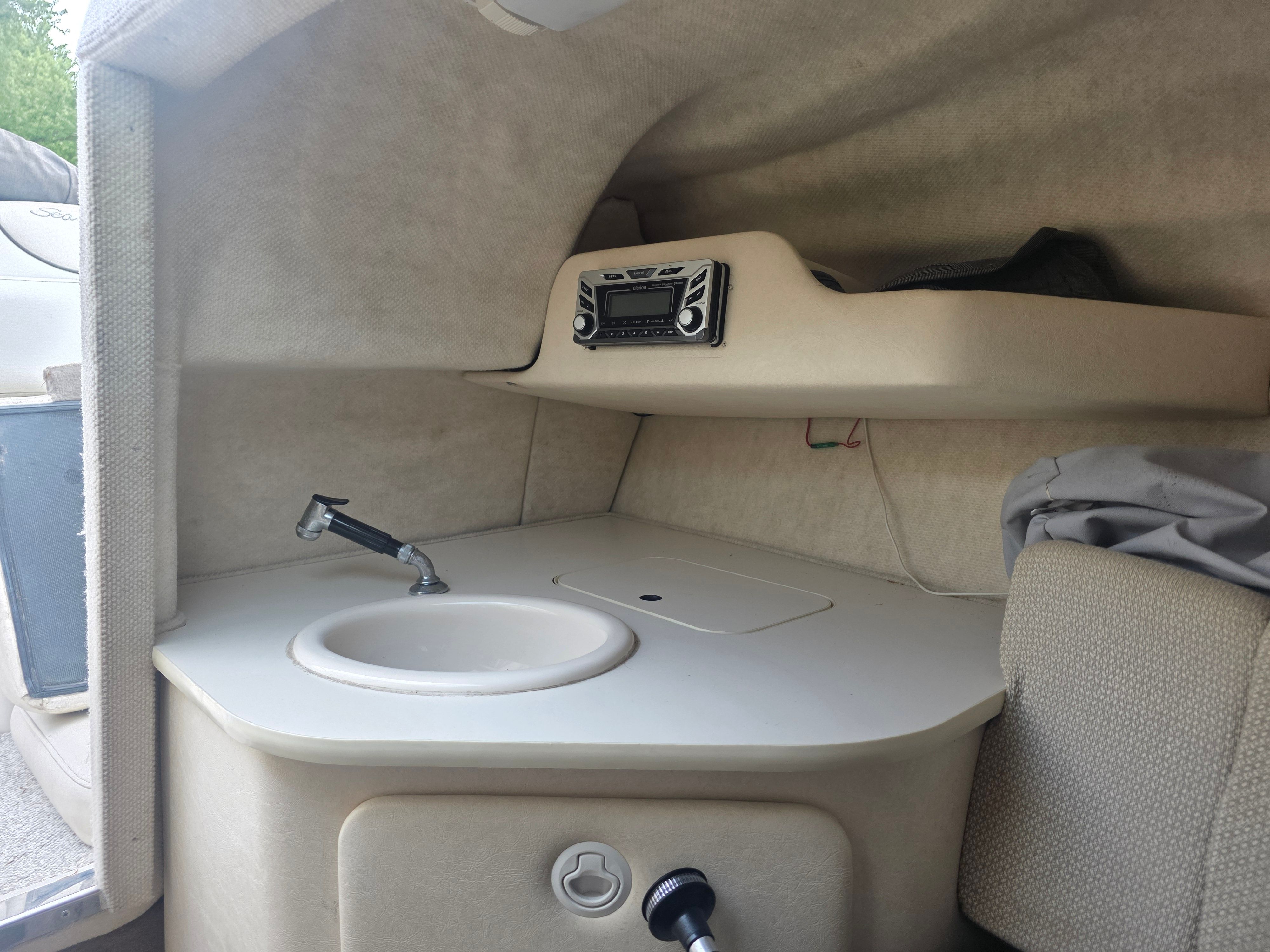 Interior of 2004 Sea Ray 225 Weekender with sink and radio.