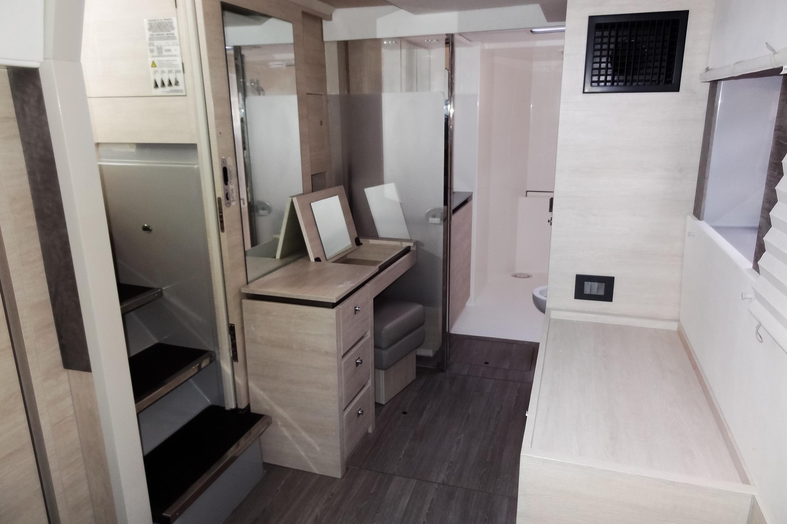 Modern interior of 2021 Leopard 50 yacht with stairs, vanity, and bathroom.