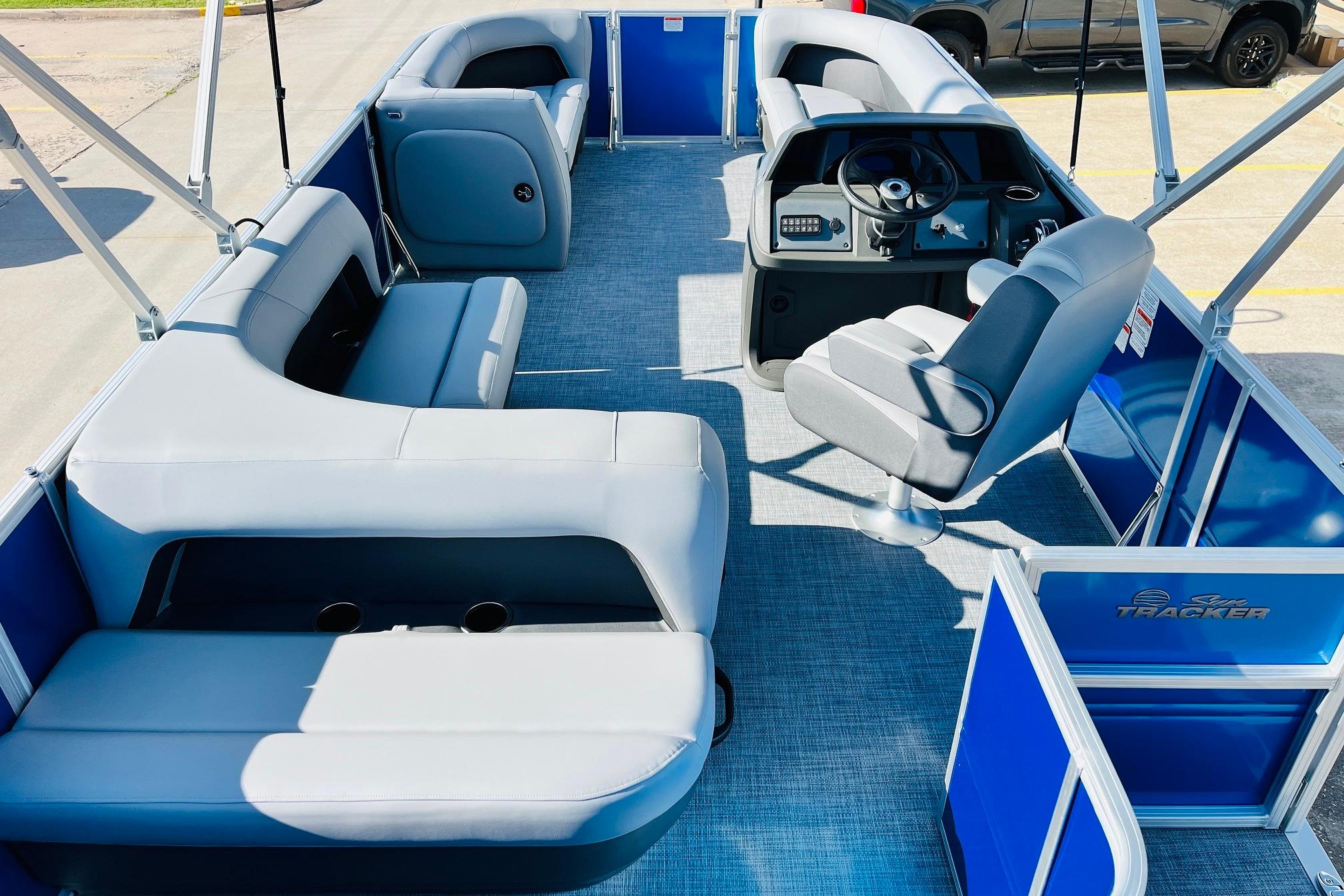 2026 Sun Tracker Party Barge 18 DLX interior with spacious seating and modern helm.