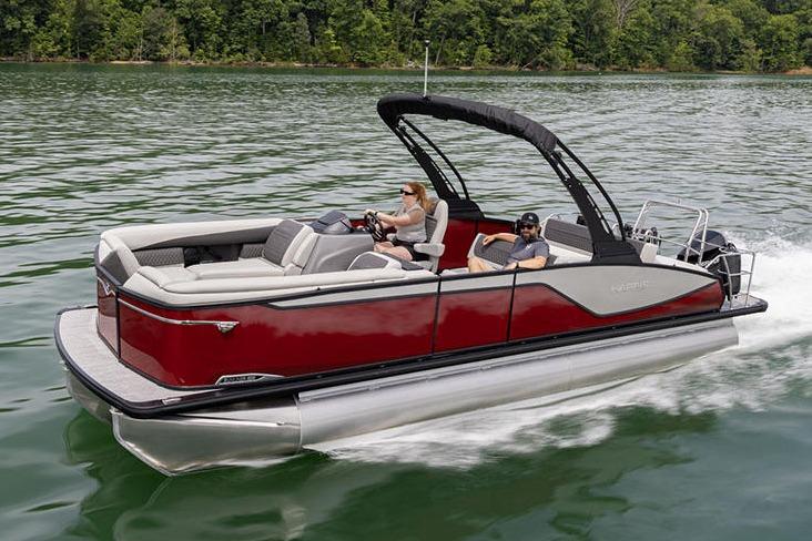 Manufacturer Provided Image: 2026 Harris Sunliner 250 pontoon boat cruising on a lake with lush green shoreline.